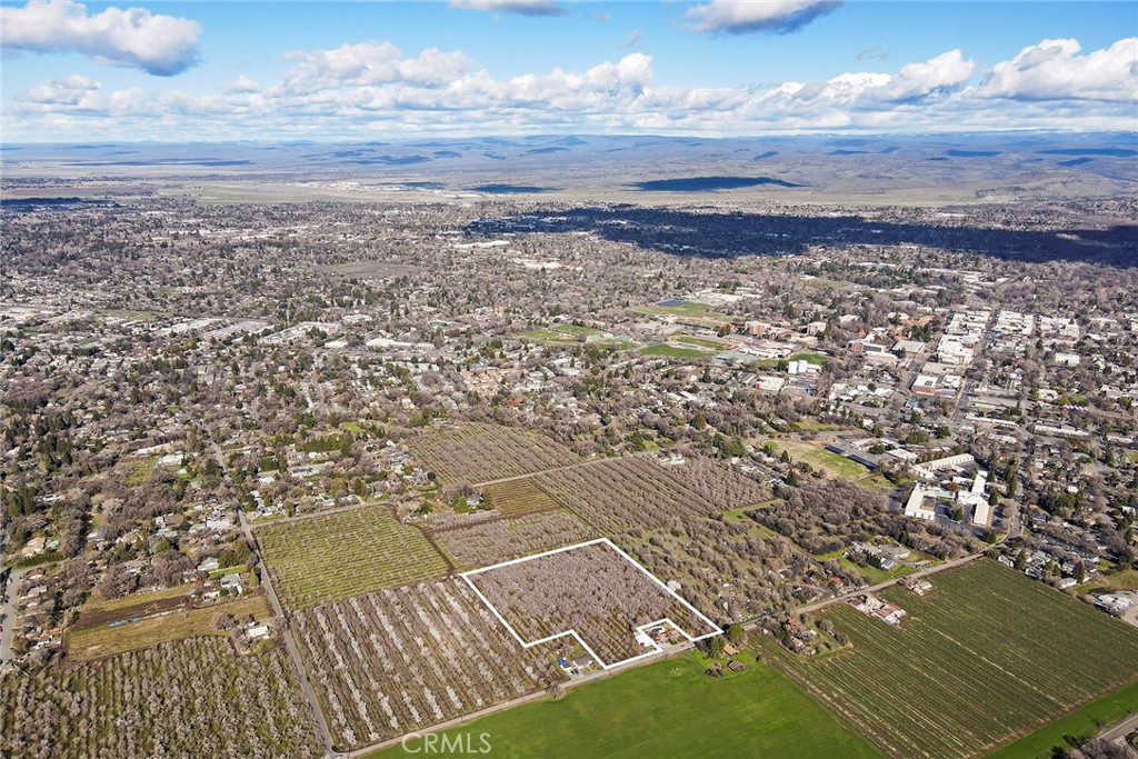 Situated just outside the heart of downtown Chico, this 8+ acre property offers a prime location for building your dream home. The land includes an almond orchard with various aged trees and moveable pipe sprinklers. Additionally, a 3-bedroom, 2-bath manufactured home provides a convenient option for related living or guest accommodations.