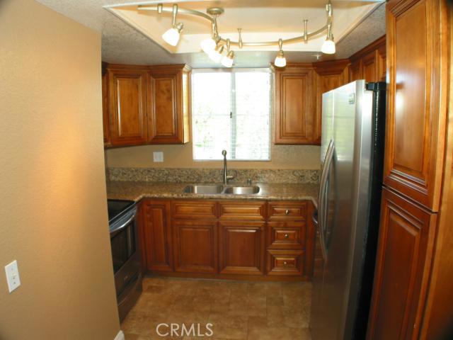 Coveted Canyon Hills Carriage unit. Fantastically renovated and upgraded 2 bedroom 2 bath upper end unit with no one above or below you. This property features an updated kitchen with slab granite counters & custom made maple cabinets with self-closing drawers, and stainless appliances. The open living/dining area has dynamic tile flooring. There is a great master bedroom with upgraded carpeting, walk-in closet, and an attached restored full bathroom with a large vanity & granite counter top. The 2nd bedroom and bathroom have been nicely updated as well with newer vanity with granite top. There are newer interior doors & baseboard as well as plantation shutters and interior laundry. The home has been tastefully painted with two tone paint throughout. The 1 car garage is conveniently located underneath the unit and there is ample shared parking as well. The complex has a refreshing pool, spa, club house, and gym. The home is located next to Peter's Canyon Regional Park which has many outdoor activities. You can easily access Jamboree and Chapman or the 241 & 261 Toll Roads. Call for a private showing today!