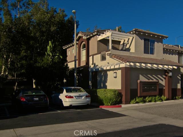 End unit townhome in a secluded and private end of the street of a beautiful complex. This unit is a 2 bed,2.5 bath with 2 car direct access garage with a nice size wrap around landscaped yard/patio. Security system,recessed lighting,granite fireplace,private balcony,custom painting, italian tile entry. Relaxing pool near by and play ground for the kids. Walking distance to Foothill Town Centre Shopping and entertainment, plus Whiting Ranch for the outdoor enthusiast. Come and see today before its gone!