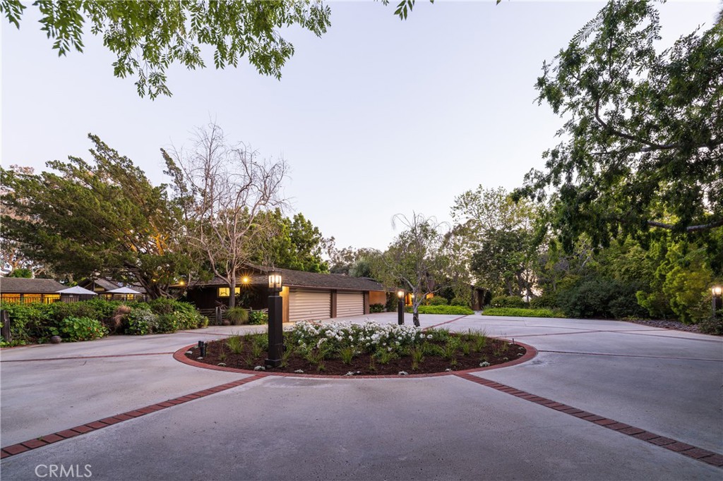 Nestled atop the serene bluff overlooking Newport Harbor's Back Bay, 2600 Mesa Drive presents a rare gem in Newport Beach - one of the largest residential lots in the city. This sprawling estate covers over 3.5 acres of meticulously landscaped grounds, offering unparalleled privacy and spectacular views of the entire Back Bay. The property features a single-level ranch home, spanning nearly 7,000 square feet of elegant living space, which has had the honor of hosting numerous presidents, vice presidents, governors, and other dignitaries, adding a rich historical layer to its allure. Designed with meticulous attention to detail, the home boasts 6 bedrooms and 8 bathrooms, offering ample space for luxury living and grand-scale entertaining. A testament to thoughtful design, the residence is positioned to capture the breathtaking morning sunrises from the east and the mesmerizing sunsets in the west. With 381 feet of view frontage, residents can enjoy panoramic vistas of the water, making every moment at home a picturesque experience. The estate's outdoor amenities are equally impressive, featuring a tennis court, a pool house, and a sparkling swimming pool, all designed to provide unparalleled outdoor living experiences. The property is zoned equestrian and is permitted stabling up to six horses. The property's architecture and layout were carefully planned to blend seamlessly with its natural surroundings, ensuring that each day is greeted with the sun's warming rays and concludes with a stunning display of color over the water. This exceptional estate offers a unique opportunity to own a one-of-a-kind piece of paradise in Newport Beach, where luxury meets natural beauty in perfect harmony, enriched by its legacy of distinguished guests.