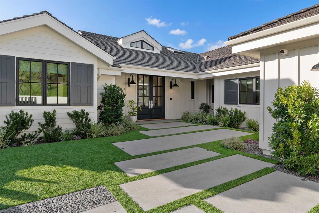 This stunning, custom single-level modern farmhouse embodies luxury living at its finest. Newly constructed in 2021 and then extensively remodeled in 2022 with sophisticated high-end finishes and superior construction. Designed by architect John Jensen and built by Greg Agee, this home is impeccably decorated with classic modern touches by renowned designer Susan Spath and lies within the Covenant of Rancho Santa Fe. As you enter the home, a stunning Baccarat chandelier catches your eye and lures you into the expansive great room with westerly views including electric sunshade blinds and accompanied by gorgeous sunsets. With just under 5,000 square feet of living space, no detail was spared featuring Terrazzo kitchen countertops with a pop-up TV, Décor appliances with double refrigerators, an expansive mud room, French oak wood flooring, custom wallpaper, and a gorgeous floor to ceiling marble fireplace. This home is a sanctuary complete with an opulent primary lavatory including lavender Calacatta marble, towel warmers, 2 separate water closets, and a flotation bathtub. Lastly, the spacious guest house, serene swimming pool with gorgeous westerly vistas, an inviting veranda and a fun putting green are all ready to welcome you home.