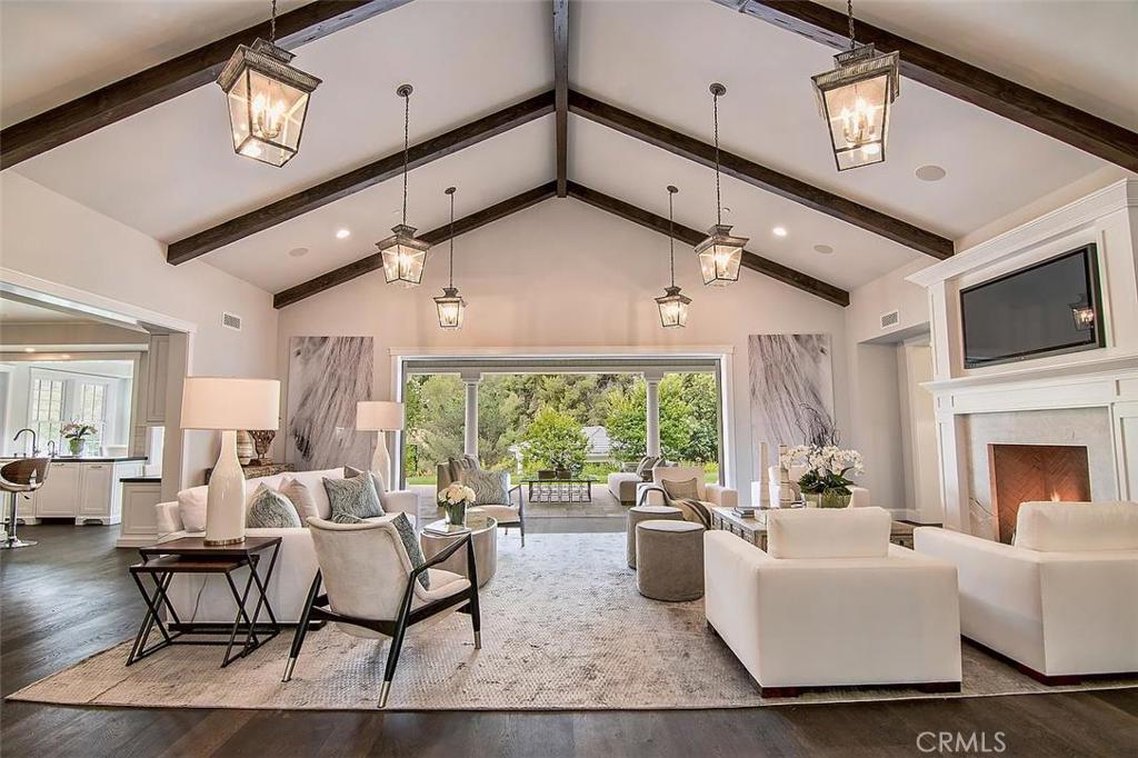 Newly built, private gated view Estate in guard gated Hidden Hills spanning apx. 9,000 square feet, featuring main, guest & pool houses, and 5-stall barn with tack room & arena, on over two private acres. Highlights in the main house include five en-suite bedrooms, spacious chef’s kitchen with granite counters, farm sink & professional appliances,garden room with stone floors & walls of glass, library, formal dining room with coffered ceilings, media room, wine cellar with tasting room, and upstairs study area.
The sumptuous master suite features dual walk-in closets, wet-bar, laundry area, private balcony, and spa like bath with steam shower & freestanding tub. The lushly landscaped private grounds include a sparkling pool & spa, outdoor loggia with beam ceilings, fireplace, BBQ & refrigerator, 4-car garage, and security system, all with wonderful privacy and commanding views. Blending refined craftsmanship and timeless design, this one of a kind estate offers the best of both New England charm with California relaxed informality.