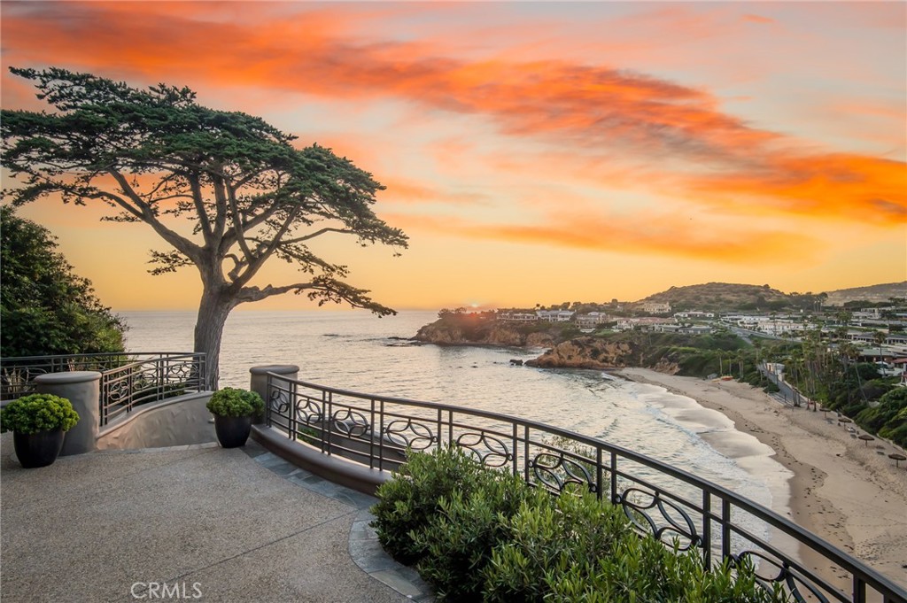 Perched atop a cliff in the prestigious enclave of Emerald Bay, this extraordinary estate, among merely three with direct private access to the waters below at Irvine Cove, offers boundless vistas of the ocean, Catalina Island, Palos Verdes and roaring whitewater just beneath you. Designed with intention to capitalize on both, the ever-changing views & privacy from neighbors, this residence occupies one of the most expansive lots within Emerald Bay as well as the Coast with nearly 100’ of frontage. Multiple terraces, mature landscaping, and a cove-facing hot tub were meticulously envisioned to maximize the natural slopes and endless views of crashing waves. A spectacular towering cypress greets you as you enter the estate while sea lions, dolphins, ospreys, yachts, and more entertain. A soft contemporary design intersects with functionality, resulting in inviting interiors that lend themselves to everyday living and entertaining. The different wings add privacy for family and guests. Soaring ceilings create voluminous spaces throughout the residence. Walls of glass opening to the terraces bring the Pacific Ocean and beyond indoors and it feels as if you’re sitting on top of the water. The muted palette of natural materials such as wood and limestone, curated to not compete with the coastal beauty, creates a soothing environment. Grand in scale, the main areas of the property as well as all bedrooms face outwards towards the multiple water-facing terraces. The owners’ suite spans nearly an entire level of the home, creating a private retreat with a spectacular view balcony. The rarity of this vastness while designed to optimize privacy from neighbors of this oceanfront estate cannot be overstated.