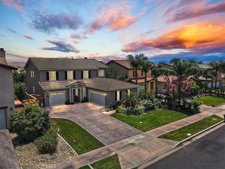 Welcome to 15559 Cleveland! Talk about CURB APPEAL! Stunning 5 bedroom home with a lush landscape, 3 car garage, and an oversized driveway! Spacious open floor plan throughout the main floor with beautifully painted grey walls, deep rich wood flooring, crown molding, recessed lighting, and big bright windows with plantation shutters! Large formal dining and living room that could be used as a den or office. The living room has a white gas fireplace, custom dark wood built-ins and opens up right into the dining area and kitchen! Bright white kitchen with granite countertops, center island, tons of cabinetry, and stainless steel appliances. Main floor bedroom with an attached full bathroom! The main floor also has a great sized laundry room and a half bath. Upstairs there is a loft, 4 bedrooms, and 2 full bathrooms. The spacious master bedroom with a separate room/seating area, 2 walk in closets, and an ensuite with a stand up shower, soaker tub and double vanity sinks. This backyard was built for entertaining! It has a covered patio, built in fire pit, an outdoor kitchen with a bar top, and beautifully landscaped. Located minutes from Victoria Gardens mall, shopping centers, restaurants, parks, freeways, and more!   CLICK ON LINK FOR A 3D TOUR - https://unbranded.youriguide.com/15559_cleveland_dr_fontana_ca/