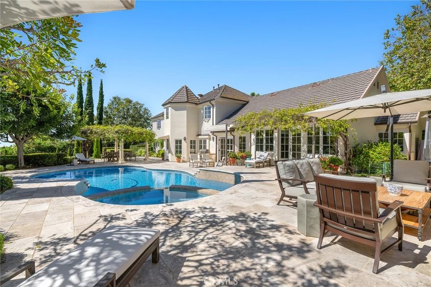 This elegant custom estate which sits behind the guarded gates of San Juan Capistrano's prestigious Hunt Club community will surely captivate you and want to call it home! Beautifully landscaped front lawn leads you into a grand two story foyer with an open beam ceiling and a stunning circular staircase with wrought iron railings. A cozy study to one side and the living room on the other flows into the formal dining area which opens to the spacious backyard.  The grand family room and two separate kitchens make it perfect for entertaining. The main kitchen offers modern touches with its quartz countertops, large breakfast nook, an island, a built in Sub-Zero refrigerator, and Wolf appliances including a 6 burner range and double ovens.  Six bedrooms and five and a half bathrooms in all, with a primary suite located on the main floor equipped with two oversized walk in closets, separate vanities, separate shower and a soaking tub, including a detached guest suite. The private backyard is terraced with a saltwater swimming pool and spa, a custom fireplace, built in barbeque, lighted tennis courts and your very own rose garden. Close to St Margaret's and J Serra and many fantastic schools. Close to charming San Juan Capistrano with quaint eateries and shops. Ten minutes to the Beach! Thirty-nine miles of equestrian trails and mature greenery, close to parks for hiking. Easy freeway access.