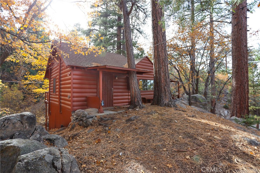 Discover the charm and potential of this true "Cabin in the Woods," nestled in the San Bernardino National Forest. Just a little over a mile from the lake and close to the Village of Big Bear Lake, this cabin offers incredible hiking and biking right from your doorstep, including access to the Cabin 89 trail. The cabin provides panoramic forest views from a nice and easy level entry. The full-size loft cabin features one bedroom down below and a loft like bedroom up above- adding to the cabin's unique character. The living room and dining area are open floor concept with the kitchen. Recent upgrades include a newer roof, dual pane windows. However, there is still opportunities to add your personal touch and make this cabin truly your own. Enjoy breathtaking peace out in the woods and indulge in unparalleled stargazing. Please note: THIS IS A GOVERNMENT LEASE. No bank financing available and they are for Second Home use only. No Short-term rentals allowed or Primary Home.