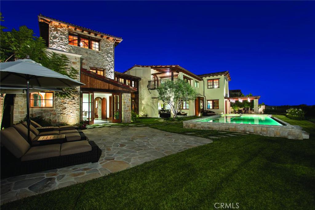 OVER $1 MILLION PRICE REDUCTION!!!!!! Hidden behind the gates of the private Crystal Cove community of Newport Coast, 9 High Water boldly overlooks a panoramic California coastline showcasing Newport Harbor and Catalina Island. Located in the highly sought-after enclave of Crystal Cove, this estate is nestled amongst the approximately 7,343 acres of dedicated untouched coastal land in perpetuity. The community boasts, parks, pools, tennis pavilions and direct beach access just to name a few amenities. This collective of custom estates form one of the most exclusive communities of the state, if not the nation.
Built in 2013, the approximately 7,566 square foot home projects from a lot of nearly 21,143 square feet. Approximately ten-foot ceilings, five bedrooms, six baths, a junior’s media room, a living room, a gym, a casita and state-of-the-art features, including solar panels, set the stage for luxe living across two stories and a third floor tower, with decorative accent lighting throughout. Decorative iron railing, large baseboards and alder beams frame the interior. A fine flooring by Richard Marshall, wide-plank hardwood, lays the foundation for the master bedroom with an ocean-facing soaking tub.