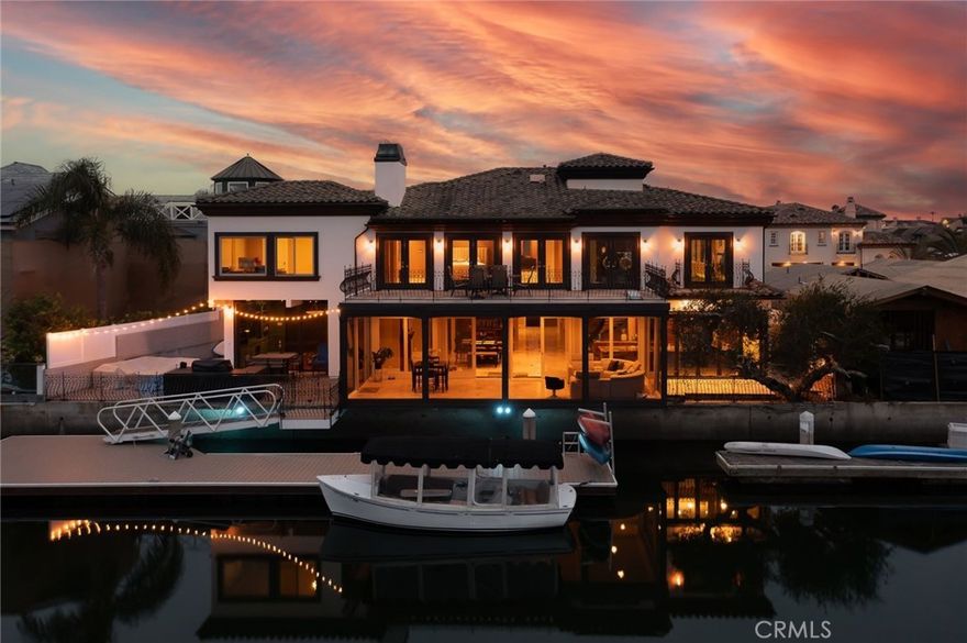 Nestled within the esteemed Admiralty Island community, this captivating waterfront residence unveils a realm of unrivaled elegance. Set at the cul-de-sac's end, this recently renovated home spans over 6,200 square feet, boasting five bedrooms, four bathrooms, a bonus room, expansive gym, and a breathtaking 500-square-foot sunroom. Delight in a host of extraordinary amenities that beg to be explored.



Embracing 90 feet of pristine water frontage, accompanied by a brand new 65-foot Trex dock, this sanctuary offers the perfect haven for a yacht or an array of watercraft. Step into the newly refurbished outdoor area, where an exquisite cooking space beckons, complete with a Lynx BBQ and resplendent granite countertops. Discover a seating area adorned with a cozy fire pit, where evenings are spent in blissful relaxation, and a picturesque fountain graces the side yard.



Inside, the kitchen stands as a chef's dream, showcasing a vast island adorned with top-of-the-line stainless steel appliances. Prepare culinary delights while savoring breathtaking water views that inspire creativity.



Ascend to the second floor via the elevator, and prepare to be captivated by panoramic harbor vistas from the master deck. The opulent master suite presents an enchanting sanctuary, offering a steam/sauna shower and a sumptuous jacuzzi tub. Pamper yourself with two walk-in closets, a cozy fireplace, a refined powder area, and ample space for an office or any other endeavor you desire.



Prominently positioned mere blocks away from the beach, this residence invites you to relish blissful days basking in the sun and embarking on serene morning strolls along the sandy shore. Revel in the proximity to the vibrant offerings of Sunset Beach, all within easy walking distance. Do not miss this extraordinary opportunity to acquire one of the most coveted waterfront properties, for it is truly a rare gem that awaits its discerning owner.