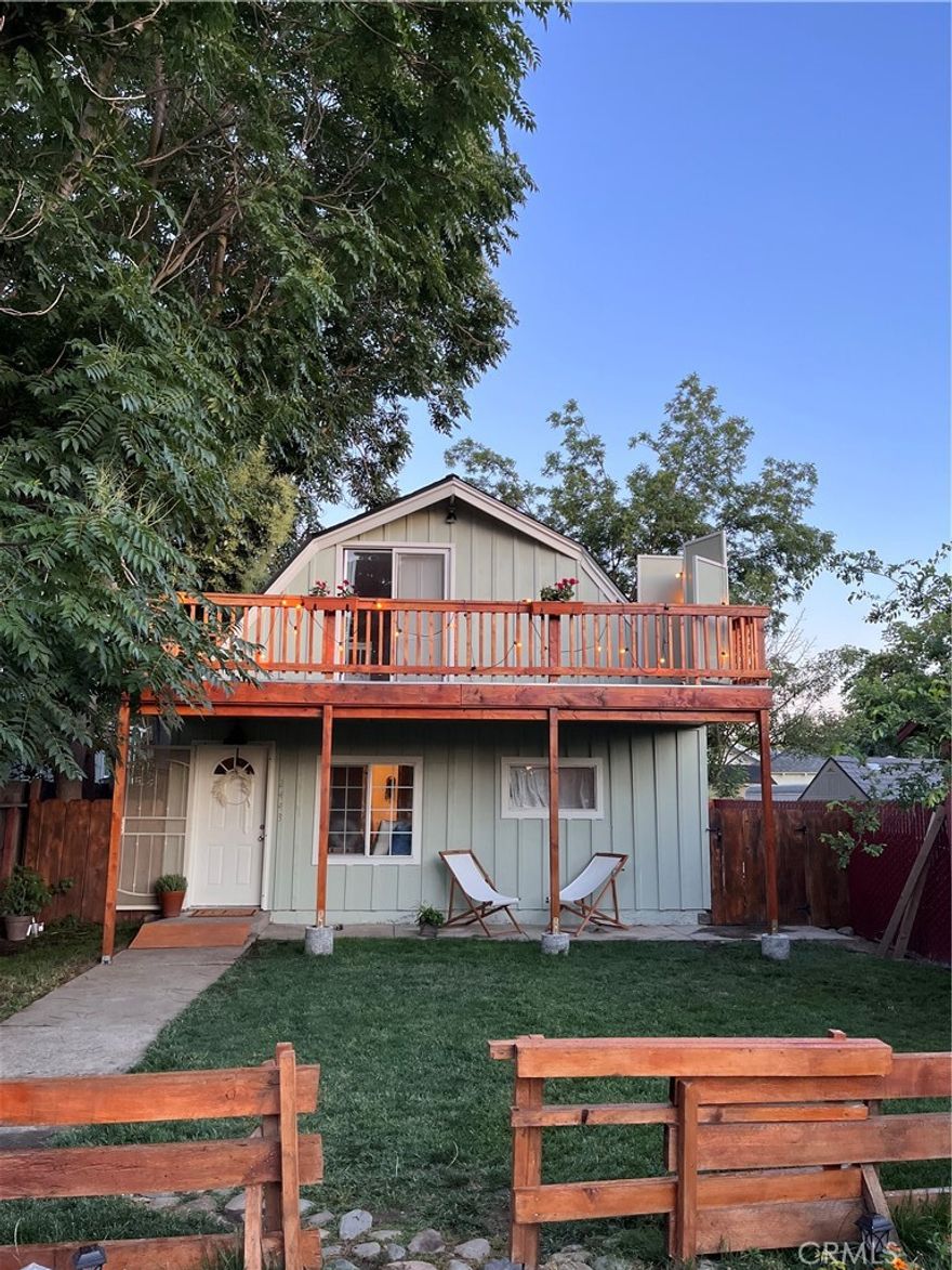 Welcome HOME! This charming 3-bedroom, 2- bathroom single-story home is not to be missed. It features a beautiful front Garden with gorgeous mature trees, an inviting pathway, a wooden fence with a barnlike gate, quaint sitting areas, and tons of privacy. The light-filled floor plan boasts an open concept, smooth ceilings, and a cozy great room for entertaining. The eat-in kitchen has tons of cabinet space, tile flooring, and a convenient indoor laundry area. A nice primary suite situated off the great room has a wardrobe closet and a private tiled bath. Secondary bedrooms are amply sized and have good closet space with storage and a full hall bathroom. Relax and unwind in your own paradise.