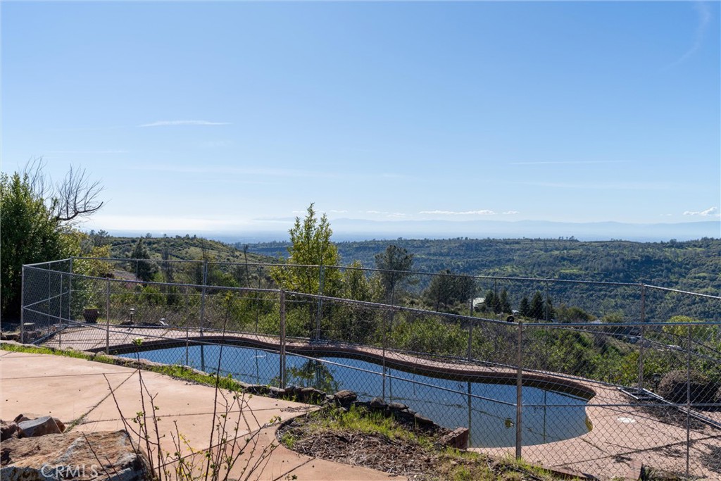 PRICE REDUCED and owner will consider "owner-carry" offers! Dreaming of the perfect spot to build your new home with stunning, panoramic, canyon views? Don’t delay because this 5.87 acre property has an in-ground gunite pool, beautiful custom gate, circular drive, fenced garden area, two pergolas and owned solar! As part of the Buzztail Community Service District the deep, community well serving this property is professionally operated by Del Oro. Other utilities, which previously served a large, custom home (lost in the 2018 Camp Fire) include PGE and septic. Wilder Rd is gated at Hwy 32 for added privacy and security and most of the private road to the property is paved, making it a pleasant, less than 20-minute drive from Chico's city limits. Over the creek and through the scenic, foothill pastures you will go . . . to your new dream home site!