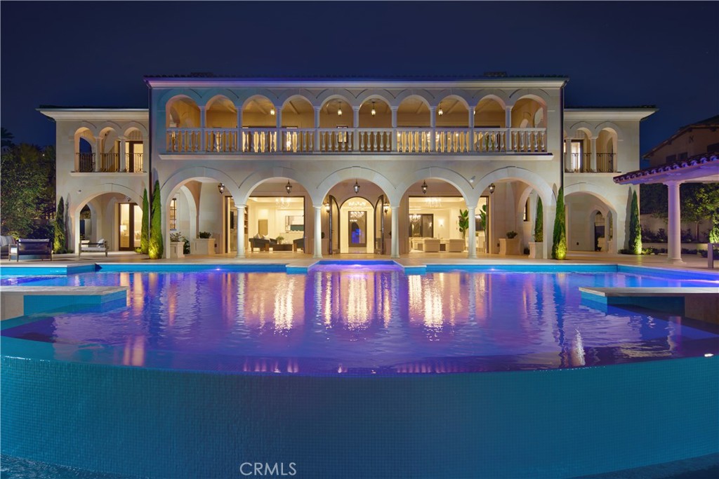 Crowning a coastal hill at the end of a private cul-de-sac behind double gates of the exclusive Estate Collection at Crystal Cove, this brand-new (2023) custom home is located on one of the most coveted streets in all of Newport Coast. Recalling the timeless prestige of a classic northern Italian villa, the grand residence is carefully positioned to capture breathtaking views. Impressive indoor and outdoor living areas frame panoramic vistas of the Pacific Ocean, Pelican Hill Golf Course, Newport Beach's harbor and channel, a verdant canyon, and romantic sunsets. First impressions are incomparable, with an oversized gated entry courtyard overlooking a lower-level courtyard and providing a private space for outdoor socializing, welcoming guests, and relaxing as the sea air refreshes. Served by a commercial-grade Garaventa Lift and highlighted by a stunning iron spiral staircase, the three-level residence embraces appx. 4,090 SF of balconies, decks, and courtyards, and appx. 11,765 SF of interiors which host seven en suite bedrooms and eight full and three-half baths. Enrichments include generously proportioned formal living and dining rooms, an office, wine cellar, 15-seat home theater, gym, maid's suite, guest house with private entrance, a secondary primary suite on the main level, and a subterranean garage spanning appx. 4,763 SF that can fit up to 15 cars. Calacatta marble flooring continues from living areas to a chef-inspired kitchen with top-of-the-line appliances, an oversized island, calacatta marble countertops, loggia, butler's pantry, and breakfast room. The primary suite opens to a covered ocean-view loggia and reveals an enormous walk-in closet, stone fireplace, espresso bar, and a luxurious five-star bath. Cantera limestone imported from Spain embellishes the exterior, while the interior offers Venetian plaster, Albertini windows and doors, book-matched Carrara marble, glass pocket doors to the outdoors, and custom alder cabinetry. Sparkling lights shine after dusk and lend enchantment to a massive vanishing-edge pool with glass tile, a fireplace-warmed cabana, loggias, large patios, and a built-in outdoor kitchen with a BBQ.