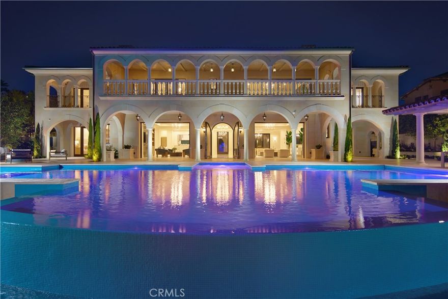 Crowning a coastal hill at the end of a private cul-de-sac behind double gates of the exclusive Estate Collection at Crystal Cove, this brand-new (2023) custom home is located on one of the most coveted streets in all of Newport Coast. Recalling the timeless prestige of a classic northern Italian villa, the grand residence is carefully positioned to capture breathtaking views. Impressive indoor and outdoor living areas frame panoramic vistas of the Pacific Ocean, Pelican Hill Golf Course, Newport Beach's harbor and channel, a verdant canyon, and romantic sunsets. First impressions are incomparable, with an oversized gated entry courtyard overlooking a lower-level courtyard and providing a private space for outdoor socializing, welcoming guests, and relaxing as the sea air refreshes. Served by a commercial-grade Garaventa Lift and highlighted by a stunning iron spiral staircase, the three-level residence embraces appx. 4,090 SF of balconies, decks, and courtyards, and appx. 11,765 SF of interiors which host seven en suite bedrooms and eight full and three-half baths. Enrichments include generously proportioned formal living and dining rooms, an office, wine cellar, 15-seat home theater, gym, maid's suite, guest house with private entrance, a secondary primary suite on the main level, and a subterranean garage spanning appx. 4,763 SF that can fit up to 15 cars. Calacatta marble flooring continues from living areas to a chef-inspired kitchen with top-of-the-line appliances, an oversized island, calacatta marble countertops, loggia, butler's pantry, and breakfast room. The primary suite opens to a covered ocean-view loggia and reveals an enormous walk-in closet, stone fireplace, espresso bar, and a luxurious five-star bath. Cantera limestone imported from Spain embellishes the exterior, while the interior offers Venetian plaster, Albertini windows and doors, book-matched Carrara marble, glass pocket doors to the outdoors, and custom alder cabinetry. Sparkling lights shine after dusk and lend enchantment to a massive vanishing-edge pool with glass tile, a fireplace-warmed cabana, loggias, large patios, and a built-in outdoor kitchen with a BBQ.