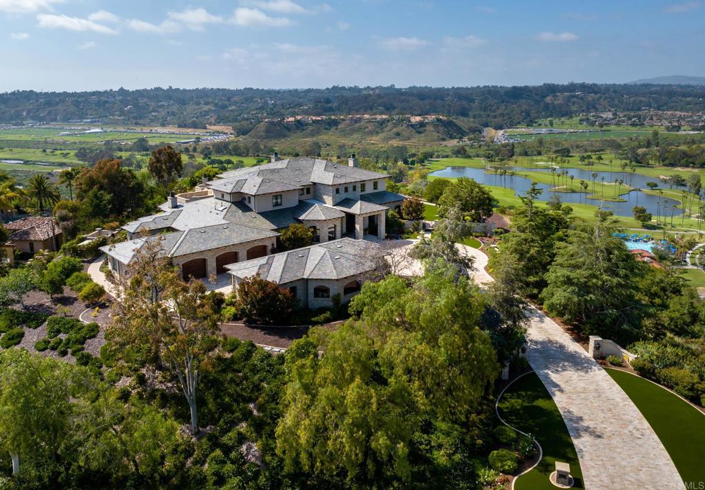 This elegant custom designed and built estate, located with-in the prestigious 24-hour guard-gated private enclave of Rancho Pacifica with stunning panoramic ocean views to the west, lush golf course views to the north and mountains to the east, is situated on one of the most desirable premier sites in all of Rancho Pacifica. Constructed in 2007 to the custom specifications of the current owner, the main residence, attached guest house, and seven car garage is nestled on 1.29 promontory level acres with just one neighbor. The residence is surrounded by mature lush foliage and meticulous landscaping creating a magnificent setting, while providing ultimate privacy. From the moment you enter the residence through the impressive front doors, you are surrounded by the highest quality craftsmanship, materials and amenities, all working together to create an atmosphere of pure elegance and drama. Inside, each spacious room reveals an artful eye for luxury. All guests will revel in large public rooms including living and dining salons, a granite flanked well-appointed chef's kitchen with adjoining breakfast alcove, butlers pantry and grand-scale great room with fireplace, open beam ceiling and professional bar, game room, climate-controlled wine cellar, state-of-the art theatre, formal library parlor and an elevator. There are five impeccable bedroom suites in the main house. The primary retreat is complete with large sitting area, stone fireplace, large outdoor deck for relaxing and admiring the endless views, his and her dressing rooms and expansive and luxurious spa bath. Other amenities include: a two bedroom, two bath attached guest house with kitchen, great room and a lanai; seven-car garage with additional storage, built-ins and epoxy floor; craft room; pool bath; fire pit; generator; outdoor living/dining room with stone fireplace; professional grade BBQ and alfresco kitchen; large resort-style swimming pool with spa, flanked with a stone waterfall; with plenty of room for lounging, sunning and relaxation. The property has been professionally decorated with custom lighting fixtures, flooring of limestone and Pecan; Albertini doors and windows; travertine, onyx, custom cabinetry, security system. Spectacular and grand and so very luxurious.