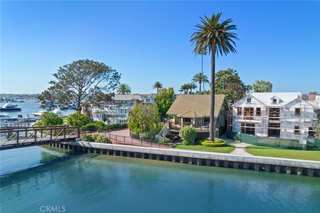 A classic traditional Balboa bay front cottage located on delightful Bay Island in the heart of Newport Harbor. Brimming with the nostalgia of simpler times and a history dating back to 1903 when the Bay Island Club originated as a "Gun Club" for wealthy Southern Californians, this romantic and refined enclave of twenty-three residences is accessed by a private bridge off of the Balboa Peninsula. Here homeowners enjoy exclusive common ownership of resplendent flowering gardens and grassy lawns, tennis, a garage parking structure, caretaker's cottage, and a wide sandy beach. Positioned on a large corner lot, 22 Bay Island has a rich past as one of the earliest homes on the Peninsula. Its original owner, William Burnham, was one of the Island's first five shareholders in 1903, and was instrumental in the development of Balboa Peninsula. With its vintage characteristics still intact the Craftsman-style home enjoys spectacular views of Newport Harbor and glistening city lights from every vantage point. An enviable address, Bay Island is just a short stroll to restaurants, shops, the Peninsula's best beaches, the boardwalk and the the world famous Fun Zone. Bring your imagination to this piece of paradise and remodel or redevelop, as this 4,400 square foot lot will accommodate a new home of up to 5,700 square feet. A private pier and dock to hold a vessel of 55 feet and side-tie complement this historic offering.