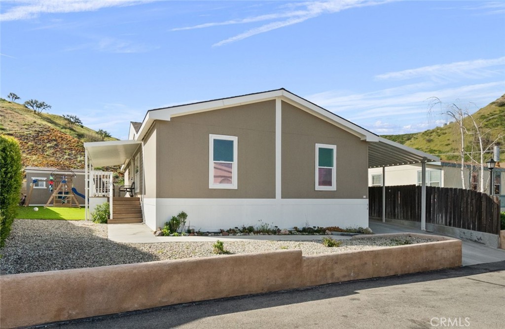 Welcome to this charming 3-bedroom, 2-bathroom Mobile Home nestled in the serene hills of Canyon Country. Located at 30000 Sand Canyon Rd Space 94, this residence boasts a spacious layout with a large walk-in closet that offers versatile options for conversion into a cozy office or den as per your needs. Immaculately maintained, the property exudes cleanliness and features an inviting open concept design, perfect for modern living.
Step inside to discover a bright and airy ambiance, complemented by picturesque views of the surrounding landscape. The interior seamlessly flows from the living area to the dining space and kitchen, enhancing the sense of connectivity throughout.
The well-appointed bedrooms provide comfortable retreats, while the bathrooms offer convenience and functionality. Your outside shed has been equipped with electricity and the backyard has a turf yard, providing a low-maintenance yet lush space for outdoor enjoyment and relaxation.
Situated in a tranquil neighborhood, residents can revel in the peace and quiet of the surroundings, making it an ideal place to call home. Whether you're unwinding indoors or soaking in the scenic vistas from your backyard, this residence offers a harmonious blend of comfort, convenience, and natural beauty. Experience the allure of Canyon Country living at its finest. ** Please Note:The space rent for this community is currently at a low $1,124 a month.