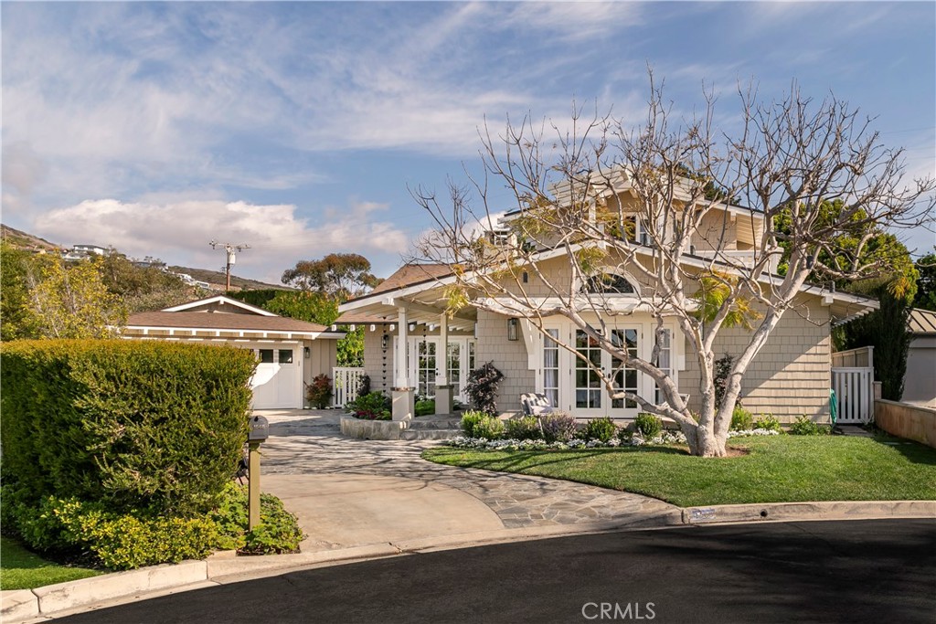 Crown Point | North Laguna Beach
Welcome to your dream escape in the sought-after Crown Point neighborhood of North Laguna Beach. Just moments from Crescent Bay’s shimmering shores, this completely updated 3-bedroom, 3-bathroom home includes a spacious two-person office, easily convertible into a fourth bedroom. Designed by acclaimed Laguna Beach architect Glen Gellatly and built in 2005, the home showcases exposed beam ceilings, a striking dual-sided Bouquet Canyon stone fireplace, and seamless indoor-outdoor living through expansive French doors.
Spanning across a 7,553 sq. ft. flat lot, this home offers privacy, space, and modern luxury. A 2024 renovation by Studio Pacific Design brings a refined Hamptons Chic aesthetic, featuring Ducheateau white oak flooring, Ann Sacks tile and marble, designer lighting, and high-end fixtures, blending coastal elegance with warmth and sophistication.
Open Floor Plan & Main Level
The open-concept living and dining areas are highlighted by high ceilings and natural light, flowing seamlessly into the private, fenced yard—perfect for entertaining. The chef’s kitchen boasts an Ilve Nostalgie 36” gas range, custom Thermador panel-front refrigerator, honed Carrera marble countertops, and a custom skylight that bathes the space in natural light.
This level also includes two bedrooms, one with vaulted beam ceilings, an ensuite bath, and walk-in closet, while the other offers built-in bookcases and abundant light. A stylish bathroom and laundry area complete the main level.
Primary Suite & Spa-Like Bath
Upstairs, the 900+ sq. ft. primary suite is a private sanctuary featuring a custom walk-in closet, built-in bookcases, and a serene balcony with breathtaking ocean and Emerald Bay Canyon views. The spa-like ensuite bathroom showcases a walk-in glass shower, Brizo fixtures, Mystery White marble, and a freestanding soaking tub, offering the ultimate retreat.
Outdoor Living & Additional Features
A lush, tree-lined backyard provides an expansive lawn and outdoor dining space, perfect for summer gatherings. A detached two-car garage offers ample parking and storage.
This stunning home is the perfect blend of luxury and coastal living—experience the beauty of Crown Point today!