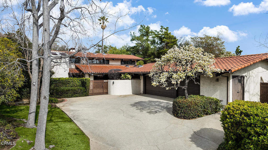 Secluded, private and serene, 1340 Oak View Avenue is a bright Spanish style home in the premier Huntington Library estate area of San Marino on a quiet cul-de-sac. Sited behind gates this special property consists of a spacious 5 bedroom / 5 bath residence with pool and north / south tennis court on 3/4 of an acre. The attractive foyer opens on the left to a grand living room with an impressive fireplace, soaring ceiling and an abundance of dramatic windows with garden views; a wet bar is tucked in at the living room foyer landing. The hallway then proceeds on the right to the formal dining room with elegant chandelier and windows overlooking the front courtyard, and then to the attractive Spanish tiled gourmet kitchen with center island, and to a large great room with Spanish tiled fireplace, skylights and wet bar. A one-bedroom suite and two bedrooms that share a bath are adjacent with views of the back garden. Beyond the kitchen are the laundry and a back bedroom and bath. A three-car attached garage completes the first level. Upstairs, the primary suite has an office / library with fireplace, a large primary bedroom and a generous primary bath with a tub, shower and commode flanked by two separate Pulman sink and closet areas. Ideal for entertaining, the exterior offers a patio with fire pit overlooking the pool, a tennis court and lovely mature plantings. Located close to Lake Street shopping, freeways, Polytechnic School, and Caltech, 1340 is wonderful!