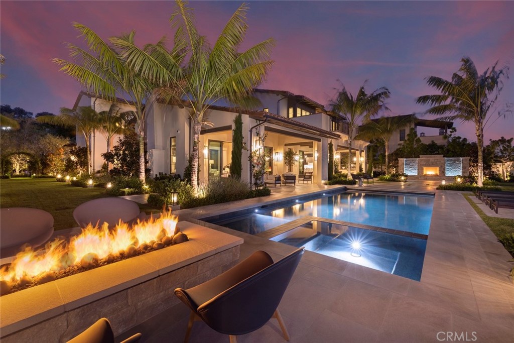 Majestically perched atop one of Crystal Coves most secluded parcels this home encapsulates resort living at every turn. Located down a private drive at the furthest end of the street with only one adjacent neighbor, light and serenity abound, offering wrap around ocean and canyon views with year round sunsets and Catalina rest in the back drop. At just over 6,550 sqft this 5 bedroom 6 bathroom residence offers vast open common spaces and cozy private bedroom suites. Upon approach of the home you are initially greeted by mature perfectly curated landscaping set amongst artful hardscapes conceptualized and executed by Peter Phillips. As you pass by the serine sounds of cascading water from the front garden’s water features you enter into the homes generous two story foyer which welcomes you to the ground floors offerings of open living spaces framed by pocket doors that marry the interiors with the exterior through courtyards and loggias, formal dining room with walk in glass wine cellar, guest suite with private lounge, rare five car garage, chefs kitchen and butlers back kitchen. The rear exterior grounds boast covered/ heated loggias, outdoor dining with BBQ area, outdoor fireplace/ fire features throughout, and glimmering pool/ spa all set around the natural beauty of the rolling canyons and the endless horizon of the Pacific Ocean. The second floor plays host to a media lounge, three secondary suites and the homes primary suite with marble clad bathroom, beautifully appointed custom closets and exterior deck showcasing expansive views. This residence is fully automated and features the latest in technology and comfort which include but are not limited to, fully integrated A/V, motorized shades, automated water/ fire features and commercial grade security system. The home represents Southern California coastal living at its finest and must be experienced to truly appreciate its value and pristine beauty.
