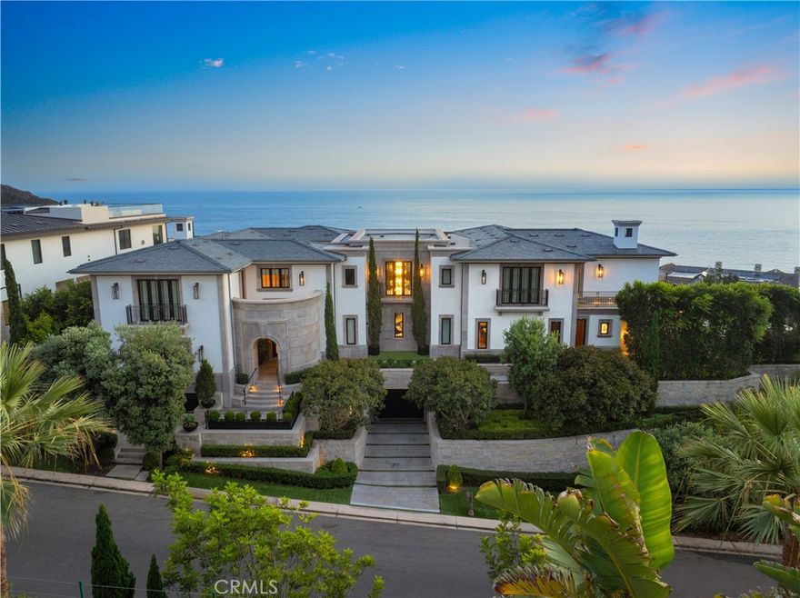 Set against spectacular panoramic views of the Pacific Ocean, Santa Catalina Island and Southern

California’s coastline, this extraordinary custom estate is one of the most coveted in Dana Point’s exclusive

guard-gated enclave of The Strand at Headlands. Embraced by a rare peninsula homesite spanning nearly

.58 acres with only one direct neighbor, the elevated property is prized for its beauty, privacy and size.

Mature landscaping and custom hardscaping combine to complement timeless architecture that is both

classic and modern, reflecting the keen eye of architect Chris Light. Interiors extend approximately 13,777

square feet and focus a spotlight on the sought-after interior design talents of Hawk & Co. Numerous Juliet

balconies, intimate decks, sprawling wraparound terraces and slideaway walls of glass pocket doors

emphasize the rewards of indoor/outdoor living, while nine ensuite bedrooms and 12 baths ensure comfort

for all. An awe-inspiring multi-level foyer with floating spiral staircase and floor-to-ceiling windows makes an

appropriately memorable first impression and leads to sophisticated magazine-worthy living spaces that

include a great room with linear fireplace and media center, a formal dining room seating 12 or more, a fully

appointed home office, and a chef-inspired kitchen with two islands, a hidden catering kitchen, new white

countertops, and pro-level appliances. A testament to understated modern elegance, the primary suite

invites serene ocean views into a private sanctuary with a spa-caliber bath and expansive wardrobe space.

Underwater views of the estate’s pool distinguish the lower level, which opens to a private yard and features

a game room, theater, second kitchen, and subterranean parking for 8 vehicles. An elevator leads to

every level of the residence, where rich materials include wood flooring, custom marble, and custom

millwork. Grounds are expansive and enrich entertaining with a massive vanishing-edge pool with Baja

shelf, a soothing spa, secret grotto, and a sunken seating area with built-in open-air fireplace. Opportunities

of this magnitude are rare at The Strand, which presents residents with exclusive access to Strand Beach, a

private waterfront beach club, miles of coastal trails and 70 acres of open space. Neighboring The Ritz-

Carlton resort, the prestigious community is moments from top-tier public and private schools, premium golf

courses, Dana Point Harbor, Laguna Beach and San Clemente.