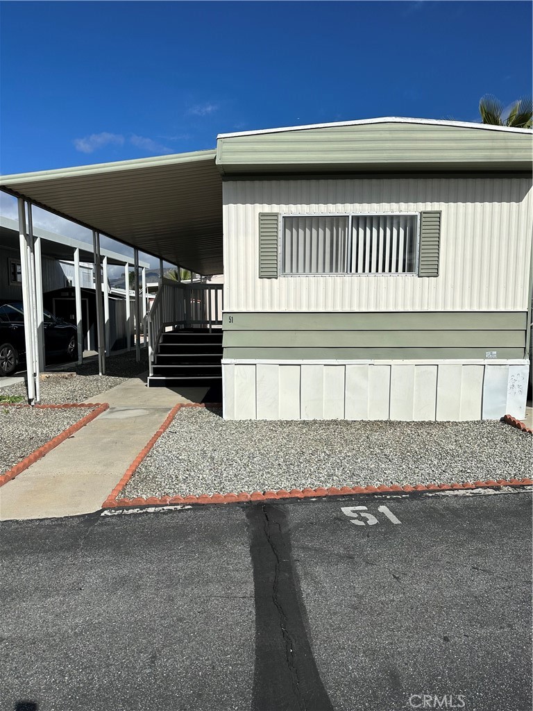 A 2-bed, 1-bath single-wide mobile home in a senior community in San Jacinto offers around 674 sq ft of space. It includes two cozy bedrooms, a full bathroom, and an open living area with a small kitchen. The exterior has a porch, and the community features amenities like a clubhouse, pool, and catering to seniors with a focus on comfort and convenience.