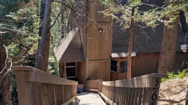A cozy cabin in the mountains with tons of potential. You will love the setting and quiet surrounding of mature pine and oak trees. This 3 bedroom, 2 bath home with a Loft is perfect to have as a get-away or live full time in. The beautiful beamed wooded ceiling greets you as you enter. The kitchen has a balcony right outside with a view that is beautiful! Work full time from this location with a perfectly situated room down stairs which has its own entrance. Come view and make an offer today!