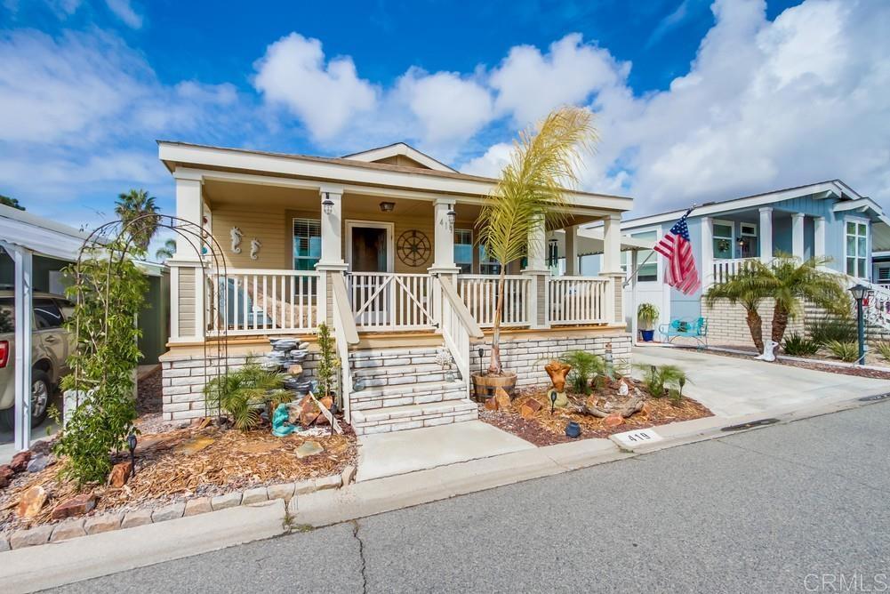 MOVE-IN READY! Stunning 55+ Home in Rent-Controlled Community Welcome to Rancho San Luis Rey, a highly desirable 55+ rent-controlled community! This beautifully maintained 2009 manufactured home offers 2 bedrooms, 2 bathrooms, plus a versatile third room perfect for a den, office, or guest space! Soaring cathedral ceilings and oversized windows fill the home with natural light. Gourmet Kitchen – Enjoy an open-concept layout with an abundance of maple cabinetry, a large work island with bar seating, and ample counter space. Inviting Outdoor Living – Relax on the large front porch or enjoy the private, fenced yard with a white vinyl security fence for added privacy. Comfort & Style – Elegant vinyl plank flooring throughout, with plush carpet in both bedrooms for added warmth. Stay comfortable year-round with central A/C. This light, bright, and airy home is move-in ready and located in a welcoming community with fantastic amenities! Rancho San Luis Rey Park is an enclave of 433 units with an abundance of amenities. tennis courts, TWO clubhouses, pools, spas and convenient laundry facilities, boat/RV storage, billiard room, Dog Park, Nearby bike path to the beach. SPACE RENT is $561 month approx (plus utilities).