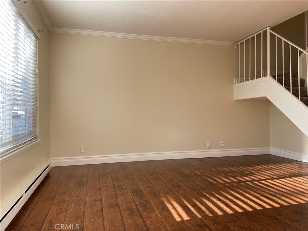 Wonderful condo located in Santa Ana's Bradford Place community! Located West of Main St. & just South of E Dyer Rd. Desirable end-unit with 3 beds & 1.5 baths. 1062 sqft of beautiful living space w/ with back-patio and 2-car garage. Open, crisp, clean, and freshly painted. New carpet, laminate-wood flooring, fans, and radiant heat throughout! Entry leads to open family room. Family leads to roomy dinning-area surrounded by wainscoting. Tasteful and open kitchen. Full Half-bath sits between family and dinning rooms. Stairs lead up to bedrooms with built-in cabinets in hall. Master is larger then guest bedrooms with walk-in closet and vanity. Master bath Jack-and-Jill's to hallway. Guest bedrooms are both roomy w/sliding-closets. Condo features two-car garage with new water-heater and shelving for storage and washer/dryer hook-ups. Back-patio is landscaped with planters. Community features beautiful green-belts, gated pool, spa. Close to shopping, schools, parks and freeways. Just a few minutes from South Coast Plaza. Condo is in fantastic condition! A great find and ready for a new owner!