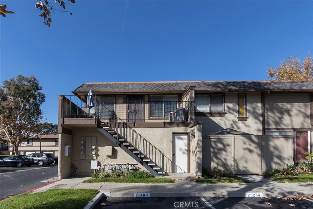 Welcome to this well maintained upstairs unit in the highly desired Aliso Villas community. With 2 bedrooms, 1.25 bathrooms, scraped ceilings and neutral paint throughout, this condo offers the perfect clean slate to make your own. The galley style kitchen enjoys plenty of natural light and offers ample storage as well as an eat in dining space. This home enjoys a gas fireplace that adds to the homey feel. There is a laundry space conveniently located just off the kitchen. The master bedroom is spacious with a walk in closet with shelving, it is also appointed with its own vanity and sink. The shared bathroom is clean and neutral with a shower and one additional sink. A one car garage is located directly below the unit. There is also a designated parking space. This community has so much to offer, enjoy the pool and playground located walking distance from this home. A must see!