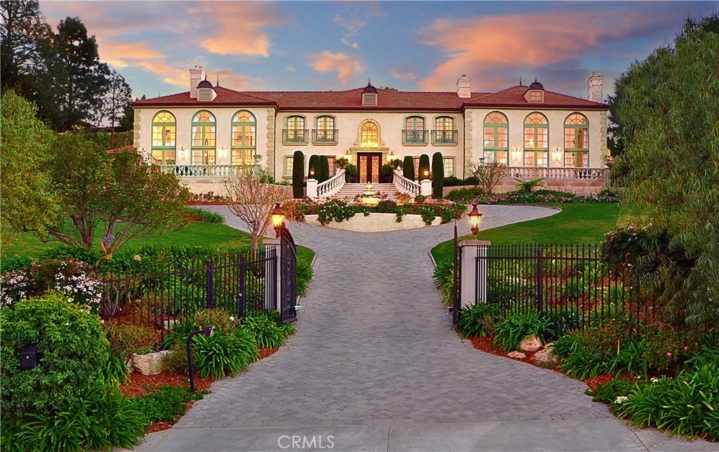 Up a long and circular driveway is where you will find “Versailles on the Hill”, this landmark estate on a spacious appx. 1-acre lot was designed to feel like you are “10 miles West of Versailles”. The recently redecorated interior of this nearly 10,000 square foot residence blends visionary design, bespoke attention to detail, and contemporary elegance, truly bright and open!! In addition to 7 BR and 11 BA, there are a grand formal living room and family room with 2-story ceilings, spacious dining area, state of the art chef’s French country Kitchen includes large 6” solid Maple Butcher Block island and Wolf and Subzero appliances, hidden study and gym, wine cellar, movie theater, game room pub and library. The open floor plan allows the main living areas to capture breathtaking views of the ocean, city, sunset and tranquil picturesque landscaped views. Outstanding amenities include a master retreat with a luxurious spa-like bathroom, 7 fireplaces, 10 chandeliers in superior quality and style, about 50 sconces/post lights in/outdoors, beautiful custom cabinetry, sparkling pool & spa, and a full built-in outdoor BBQ kitchen. Despite its scale and grandeur, the home remains warm and inviting, making it a unique retreat for intimate family life that is also appropriate for large-scale entertaining. This is a rare property that will satisfy the discerning buyer. Can never be duplicated at this price!