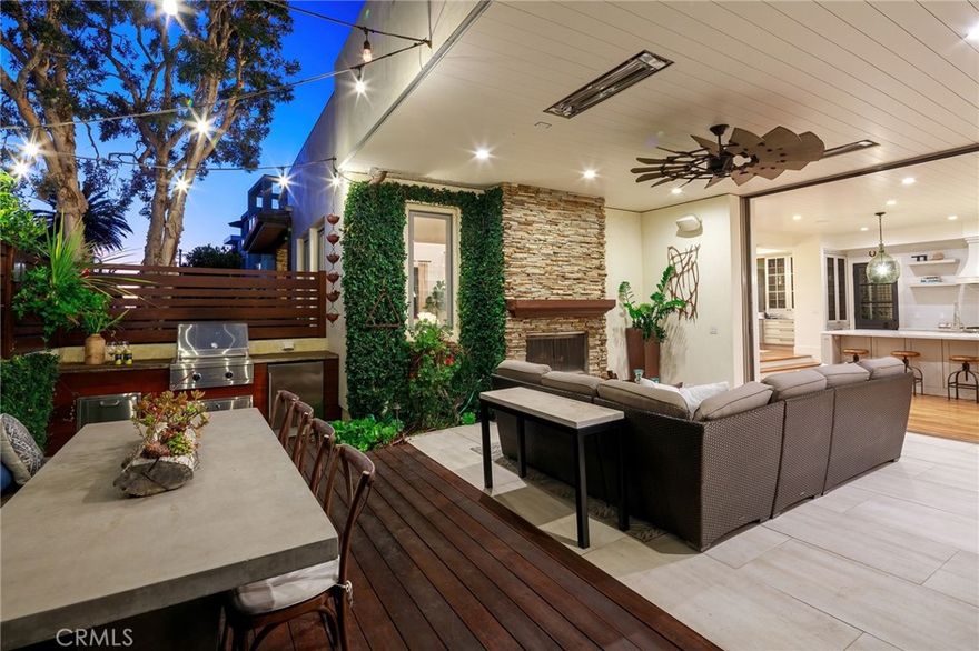 Come experience this stunning unique home in the prominent Gas Lamp neighborhood of Manhattan Beach. On an oversized corner lot, a few blocks to the ocean, in a top school district, and walking distance to downtown; this inviting home offers the ultimate beach/ farm lifestyle and includes 4 living areas, 6 bedrooms, 4.5 bathrooms and a garden area with a charming chicken coop. The main floor features soaring ceilings and sweeping walnut floors. A formal living room, dining room, and office make way to the heart of the home. Pocketing glass walls open to the terrace transforming the space into exemplary indoor/outdoor living with a fireplace, built-in heaters, grill, and beautifully landscaped pathways leading to a cozy fire pit.  Immerse yourself in the serene surroundings of lush landscaping that brings a touch of farm life to the beach. The carefully manicured gardens create an oasis of tranquility and provide a sense of privacy and serenity. The remodeled kitchen has honed Neolith counters, a sprawling island, and high-end appliances which connect to the comfortable family room. Take either the front or back staircase to get up to the second floor where you’ll find the primary suite with a large walk-in closet and oversized ensuite bathroom.  Three additional bedrooms are adjacent to the primary suite with a conveniently located laundry room and upstairs den. Then step outside to the extra large deck where you can watch the sunset over the ocean or relax in the jacuzzi.  The basement includes a custom 500-bottle temperature-controlled wine cellar, TV room, and an en-suite bedroom offering a private retreat away from the rest of the house.  Additional features include new AC units, new hot water heater, surround sound, 4 fireplaces, dual stairwells, and a 3-car garage with 18 ft ceilings and extra storage. Plus you can park 2 additional cars adjacent to the garage for a total of 5 parking spaces.  We invite you to visit this dreamy oasis located in Manhattan Beach’s special sought-after community.