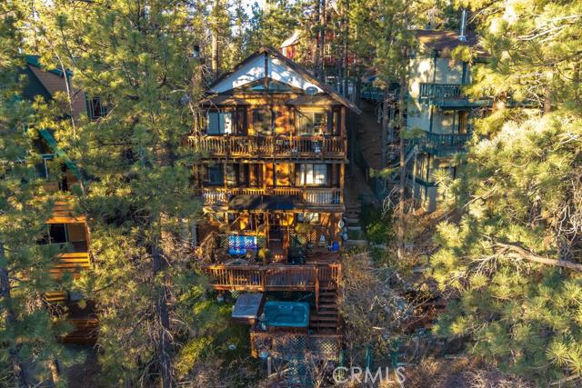 Ideal Moonridge location! You are going to love the ski slope views & setting from this recently renovated Big Bear Lake cabin. Offering you an open concept main living area, multiple outdoor entertaining spaces and 3 bedrooms, this charming mountain retreat affords you the idyllic getaway you have been looking for. You'll love the close proximity to Bear Mountain, Snow Summit, golfing, the National Forest, Shopping & Dining! You will also love the amenities right at home like the hot tub, fireplace, multiple decks, stargazing & life in the pines. If you happen to get tired of the stunning views, go inside and lose yourself in the world renowned landscape photography being generously gifted by the seller. Alta Vista Ave is one of the best kept secrets in Moonridge. You get the benefit of million dollar views without having to climb any steep roads. Amenities include updated kitchen & bathrooms, granite, slate, flooring & paint. Be sure to put this on your list of properties to view!