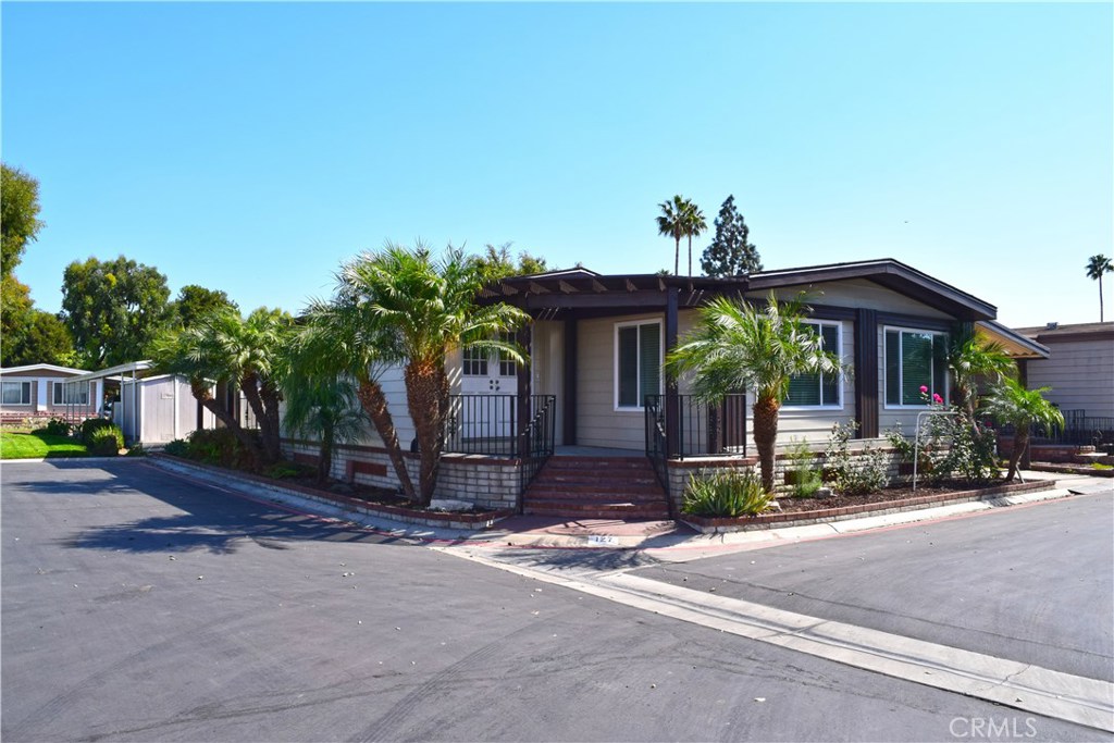 Must-see, "Triple-Wide" three bedroom / two bathroom mobile home in the Anaheim Shores Mobile Estates. Completely remodeled. This home was manufactured in 1978 by Goldenwest and boasts a 1,610 square foot floor plan. Stunning, double door front entrance. The living room is huge and features new drywall, new paint, new recessed lighting, new low-E double pane windows, as wells as new neutral laminate wood flooring. Gorgeous kitchen with new granite counter tops and is open to the bright dining area. All three bedrooms are spacious and move-in ready. Large laundry room with plenty of cabinet and storage space. Complete with a charming back porch to relax in. Additional features include: new exterior paint, storage shed, extra large carport, new baseboard, new blinds, new fixtures and more. The Anaheim Shores community is a five-star park which offers exclusive amenities to it's residents such as community events, pool, spa, club house, and more.