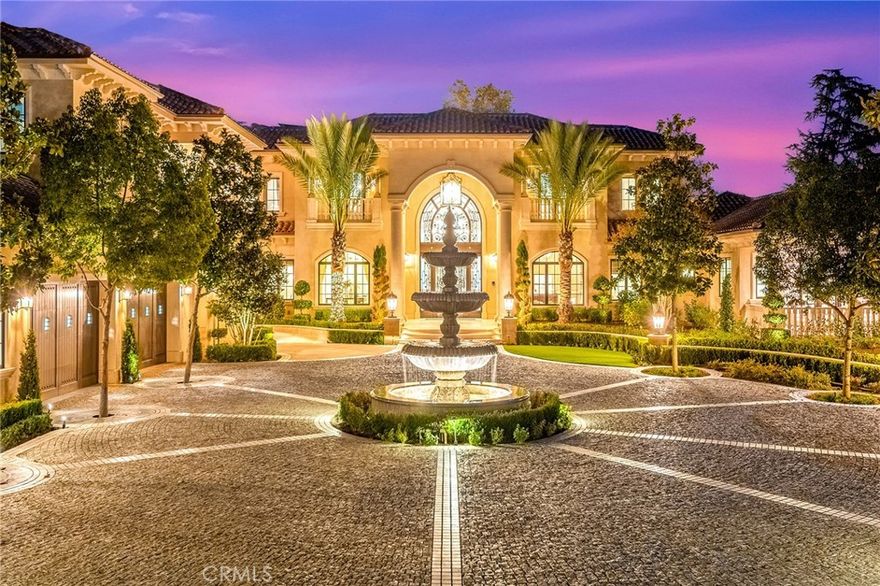 Welcome to an extraordinary estate within the prestigious Bradbury Estates, where unparalleled luxury meets timeless sophistication behind secure, guarded gates. This magnificent Tuscan-inspired residence, encompassing over 14,600 square feet, stands as a masterpiece of architectural excellence.



Drawing inspiration from the legendary Bellagio, the residence showcases an harmonious blend of classical elegance and contemporary refinement. The grand entrance immediately captivates with its two-story domed ceiling, crowned by a spectacular custom Murano glass chandelier suspended above imported Caldia marble flooring from Carrara, Italy. Hand-embroidered silk wallcoverings and Lalique crystal sculptures create an atmosphere of refined opulence.



The home's flowing layout features eight luxuriously appointed bedroom suites, each uniquely adorned with custom chandeliers and artisanal finishes. Nine impeccably designed bathrooms showcase premium marble and sophisticated fixtures. The formal living spaces boast soaring ceilings, marble fireplaces, and expansive windows that frame views of the mosaic swimming pool and meticulously landscaped grounds.



A state-of-the-art smart home system, valued at $1.5 million, seamlessly controls every aspect of this remarkable property. Additional amenities include an indoor lap pool, a climate-controlled outdoor living area with automated sliding doors, and a separate guest house complete with two bedroom suites and kitchenette. The executive wing features a sophisticated office with a conference room, while fitness enthusiasts will appreciate the fully equipped gym.



Architectural details throughout include coffered ceilings, intricate crown moldings, and bespoke cabinetry crafted by master artisans. Palm-lined streets and self-sufficient energy infrastructure complete this extraordinary estate, offering an unparalleled living experience where luxury knows no bounds.