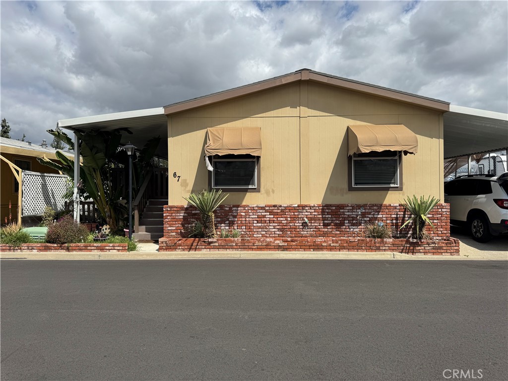 Welcome to 'KINGS WAY GARDENS MH' Park! This MANUFACTURED HOME is a 3-bedroom 2-bathroom located in the City of La Verne. Offering 1,344 square feet of living space, attached carport, and a side porch/deck with ample space for relaxation. Spacious and inviting living area with an open floor plan seamlessly connects to the dining area and well-appointed kitchen with bar counter. Kitchen features cabinetry and counter space for all your cooking needs. This unit/space only has one neighboring unit/space. The mobile park RV parking is next to this unit.
This family mobile home park is of all ages! It offers a SWIMMING POOL, 2 SPAS, CLUBROOM, PLAYGROUND, 2 LAUNDRY ROOMS, CAR WASH AREA, and DOG PARK. Come check it out!!