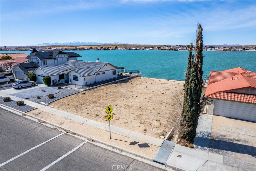 reduced price from 180,000 now 139,000 Build Your Dream Home with a Stunning Waterfront View
Imagine waking up to breathtaking sunsets over the sparkling waters of South Lake in Silver Lakes, Helendale. This level back lot offers the perfect opportunity to build your dream home in a peaceful and serene community. Enjoy the soothing sound of the water as the wind moves across the lake, with stunning mountain views in the background. With an incredibly low HOA fee of just $194 per month, you'll have access to a variety of top-notch amenities, including:
Tennis & Sports Facilities: Four lighted tennis courts, pickle ball courts, basketball courts, and a sauna with a jet spa for ultimate relaxation.
24-Hour Gym: Stay active anytime with a fully equipped fitness center.
Equestrian Area: Enjoy horseback riding, complete with tables and working spaces.
Parks & Recreation: Swim in the lake, fish, paddle board, windsurf, or take in the scenery from your private dock. Note: To maintain pristine waters, jet skis and water skiing are not permitted.
RV & Boat Storage: Convenient parking for your RV while you build, plus boat storage for easy lake access.
Community Park: Just steps away from Hot Fort Park, perfect for picnics, baseball, and other outdoor activities.
This is your chance to create a home in a scenic and tranquil setting. Don't miss out on this rare opportunity! buildings plans have been submitted and accepted by the city