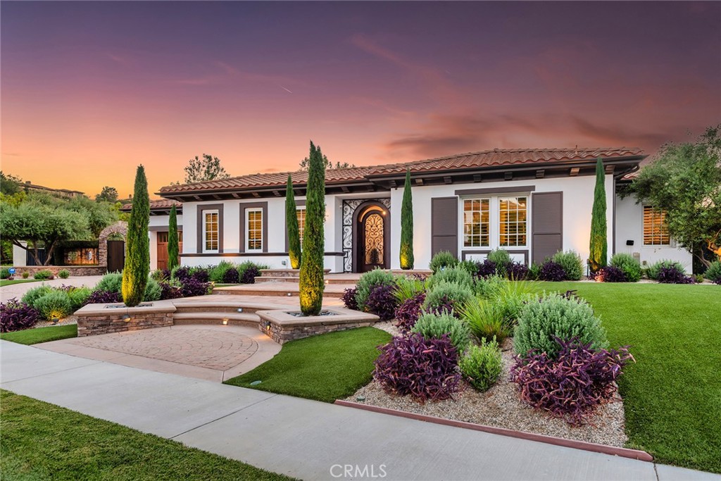 THE absolute premier landmark estate with the ultimate location in guard gated, The Oaks of Calabasas. Ideally located on a rare and exceptional double sized lot with explosive panoramic views and total privacy providing one of the most magical settings in all of Calabasas. The ultimate top of community cup-de-sac! Completely reimagined throughout, this SINGLE STORY transitional Spanish was recently designed and remodeled using the very finest finishes. Nothing else compares! Spanning nearly 5500 square feet, the open concept floorplan provides a special office/library, dramatic living room with soaring cathedral wood beamed ceilings, sensational primary suite with fireplace, two finished walk in closets and a spa like bathroom with steam shower. There is also a fantastic secondary bedroom wing with en-suite bedrooms and a teen/bonus room. The dramatic center island kitchen opens seamlessly to the "great room" and boasts top of the line appliances and custom crafted cabinetry. There is also a separate detached guest bedroom suite perfect for live in staff, overnight guests or gym. The resort quality yard has been featured on HGTV and is truly second to none. There is a custom pool and spa with swim up bar, outdoor kitchen, multiple fire features and firepit, sensational one of a kind covered outdoor living room with bathroom, multiple fruit trees, professional putting green and an abundance of high quality manicured turf. Other amenities include a spectacular outdoor entry courtyard with fireplace, interior and exterior cameras, surround sound throughout, smart home technology and so much more! A VERY special offering!