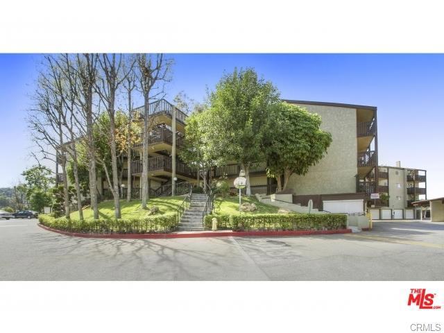 Arroyo Seco Village is an amazing and gated community consisting of 7 buildings in Los Angeles (Highland Park area). The complex is nestled on a hilltop with 360 degree view of the surrounding city and the gorgeous courtyard within. This wonderful 2 bedroom 2 bath condo won't last!!! This recently updated condo is located on the second floor and offers wood laminate flooring throughout, crown molding and 5" baseboard. The living room has sliding doors that open to a lovely deck area. The mature vegetation and the sounds of the nearby water fountain creates a wonderful atmosphere. The kitchen offers granite counter tops with back splash. Both bedrooms have views of the outdoor gardens and bathrooms with newly tiled flooring and laundry hookups in the suite bath. This unit comes with 2 side covered parking spaces. H.O.A. offers amenities including a pool, spa, sauna, BBQ area, basketball corner, and a playground. Stroll through the meticulous garden pathways in the center of the complex. The complex is close to Debs Park, Highland Park Rec Center, public transportation and easy freeway access. PS. This complex is pet friendly.