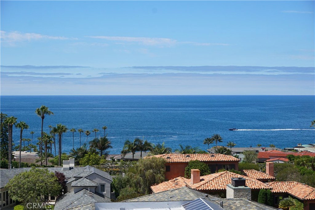 Located in the exclusive private beachfront community of Irvine Cove, this gracious five bedroom plus office home is situated on a large pie-shaped and ultra private lot, capturing breathtaking ocean, Catalina Island and sunset views. Hallmarks of this stately and well-designed home include high ceilings, large living spaces, and picturesque vistas from almost all rooms in the home. The entry foyer leads to a large living room with double height ceilings and floor to ceiling doors and windows, allowing for an abundance of natural light. The chef’s kitchen offers ocean views and backyard access and is adjacent to the formal dining room with rich wood paneling. Featuring gorgeous wood cabinetry, the cozy and inviting family room provides easy access to the spacious backyard, complete with pool and spa, retractable awning, and full bathroom. Additional features of the main level include a bedroom suite, theatre with projector and screen, office, wine cellar and wrapping room. The second level is comprised of three generous bedroom suites and an adjacent study/play area and balcony and a spacious master suite with adjacent office, both of which boast extraordinary views. The recently remodeled and spa-like master bath has Carrara marble countertops and accents and gorgeous oversized walk in closet. This is a wonderful opportunity to own a premier property in prestigious Irvine Cove, which features a stunning quarter mile long private beach, tennis court and park.