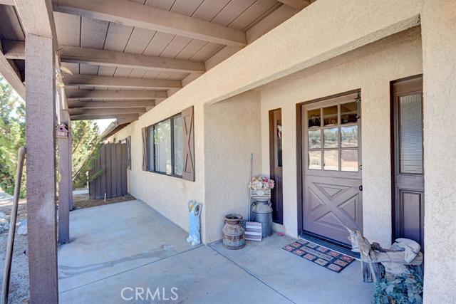 Cute Country Home! Turn Key 3 bedroom 2 bath with ceiling fans throughout. Home has been well cared for and has had many improvements. Master has a cute wood burning stove as well as a fireplace in the living room. Tile/wood-look flooring, carpet, paint, new back patio slab, stucco.... Two car detached garage with dog house/shed in the back. Two car detached shop/garage/carport that could easily be converted to an apt, already plumbed for bathroom and has a wood-burning stove. Property is completely fenced with automatic gate.