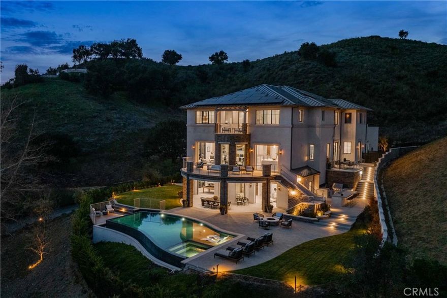 Experience the epitome of the Malibu Valley lifestyle, where luxury meets natural beauty, and every detail has been thoughtfully curated for those who demand nothing but the best. Sited on one of Malibu Valley's last remaining promontory view sites, this brand-new construction Contemporary Transitional estate features breathtaking panoramic views of the Santa Monica mountains, soaring 12-20ft+ ceilings

Property Highlights

Living Space: 10,405 sq ft (8,305 sq ft interior) on a sprawling 2-acre lot.

Bedrooms: 6 en-suite bedrooms, each luxuriously appointed for comfort and elegance.

Amenities:

Resort-style living: Movie theater, game room, lounge, library, study area, and a top-floor living room.

Gourmet chef’s kitchen: Designer millwork, imported slab countertops, walk-in and butler’s pantries, a large eat-in island, and premium Gaggenau and Thermador appliances.

Primary suite: Features a private balcony, a fireplace, dual walk-in closets, and a spa-like bathroom with a soaking tub and a massive shower.

Entertainer’s dream: Dining room with chilled wine storage and optional gym.

Car enthusiasts: 3-car garage and a private motor court with ample parking.

Outdoor Oasis

Step into your private backyard sanctuary featuring:



Infinity-edge pool and spa: Designed to take full advantage of the stunning canyon views.

Outdoor kitchen and bar: Perfect for entertaining or relaxing under the Southern California sun.

Grassy lawns and fire pit: Create the ultimate setting for outdoor living and dining.