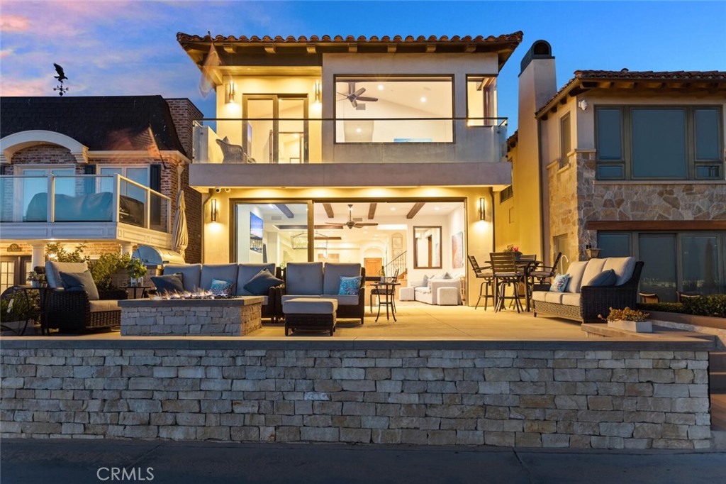 Welcome to an unparalleled oceanfront retreat on the iconic Balboa Peninsula in Newport Beach. This rare gem offers breathtaking, panoramic views of sandy beaches, Catalina Island, sparkling ocean waters, and the Balboa Pier from both levels of the home, creating an unrivaled coastal living experience.
Step inside to discover a thoughtfully designed open floor plan, where luxury and functionality harmonize seamlessly. The chef’s kitchen is a culinary masterpiece, featuring a center island, a 48" Wolf range, a Sub-Zero refrigerator, and premium finishes. The kitchen flows effortlessly into the dining and living areas, highlighted by floor-to-ceiling Weiland glass doors that invite natural light and coastal breezes into the heart of the home.
This residence boasts four spacious bedrooms, including a stunning primary suite that serves as a private sanctuary. The primary features a walk-in closet, a cozy sitting area, and a spa-inspired bathroom with limestone finishes, a freestanding soaking tub, and a private balcony, where you can savor mesmerizing sunsets over the Pacific.
The home is outfitted with a state-of-the-art AV system and Control4 automation, providing seamless control of entertainment, motorized window shades, lighting, and security features, including cameras and an alarm system, for effortless living. Adding to its appeal, this property comes fully furnished with exquisite Restoration Hardware furniture, blending style and comfort to perfection.
Outdoor living is elevated with a raised and oversized front patio, perfect for entertaining or quiet relaxation. Equipped with a cozy fire pit and a built-in BBQ, this space is ideal for enjoying the ultimate beachside lifestyle.
Additional luxury amenities include DuChateau plank hardwood floors, Walker Zanger tiles, A/C system, surround sound, recessed lighting, Anderson windows, wood beam ceilings, and a freshly painted two-car garage with epoxy flooring and carport parking.
Nestled in the heart of coastal charm, this home offers easy access to beach activities, as well as nearby attractions like the Balboa Pier, Fun Zone, Balboa Ferry, top-tier restaurants, and boutique shopping. The prime location, set further from Newport Pier, offers a quieter and more peaceful ambiance while still providing convenient access to vibrant nightlife when desired.
This is more than a home; it’s an invitation to live the Newport Beach dream. Coastal living doesn’t get finer than this.