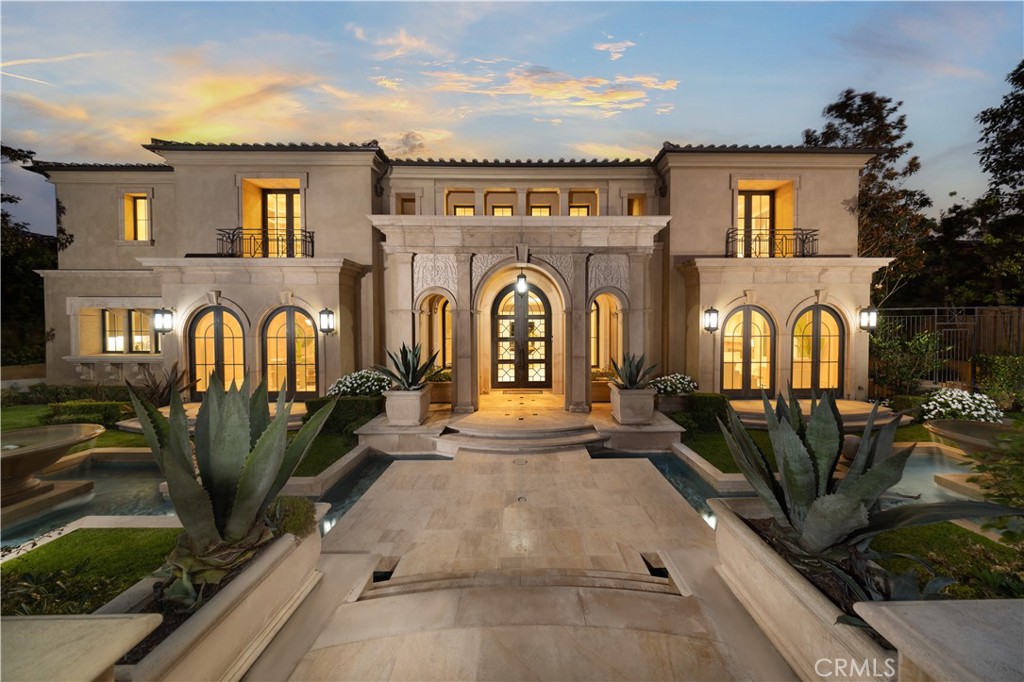 Located within the exclusive custom home community of Pelican Crest, this magnificent estate offers the pinnacle of luxury living, blending modern style with timeless elegance. Spanning over 10,300 sq. ft. and featuring a flowing open floor plan, the home is enhanced by soaring two-story ceilings and seamless white French limestone flooring.
An impressive entry hall welcomes you with grand double glass iron doors and a sweeping floating staircase, serving as a central hub that connects to spaces designed for lavish entertaining. The formal dining room boasts floor-to-ceiling windows, while the chic gourmet chef’s kitchen is equipped with top-of-the-line Viking and Miele appliances. The family room invites warmth and connection, featuring an onyx fireplace and wet bar, and opens through three sets of French doors to the spacious backyard, ideal for indoor-outdoor living. A convenient main-level bedroom suite adds to the home's allure.
The lower level spares no detail, offering a private gym, sauna, stunning wine cellar, and a state-of-the-art home theater. Upstairs, discover an extravagant master retreat complemented by a luxurious spa-like bathroom featuring his and her showers, and other three bedrooms each feature their own ensuite bathrooms. The resort-style backyard provides an idyllic setting for grand gatherings, featuring a vanishing infinity-edge pool, spa, fire pits, and a built-in BBQ, all framed by breathtaking canyon and peek-a-boo ocean views. The property sits on a generous lot that enhances privacy and tranquility.
Living in the guard-gated Pelican Crest community provides access to world-class amenities, including fine dining and shopping at Fashion Island, nearby golf at Pelican Hill Resort, and easy access to Newport Coast's pristine beaches and John Wayne Airport. This estate truly exemplifies refined living at its finest!
