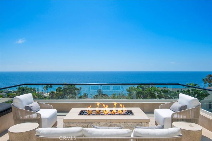 Panoramic, unobstructed views of the iconic coastline, ranging from Dana Point all the way to Palos Verdes, take center stage at the immaculate contemporary residence. Representing the pinnacle of luxury coastal living, this property features approximately 4,350 square feet of tastefully appointed interiors and three spectacular decks. Beyond the large driveway, this home's entryway includes a foyer and elevator access to the primary living levels. On the floor above, a grand formal sitting room offers dramatic double-height ceilings, an adjacent office or play zone nook, and the largest outdoor space, complete with a fire pit. Ocean, Catalina Island, and city light vistas are framed by oversized windows of this meticulously updated masterpiece in the heart of Wood’s Cove. The next level features a harmonious blend of a living section, a dining area open to the story below, and the home's grand kitchen. The thoughtful layout seamlessly integrates the entertaining spaces around a large fireplace and a second balcony perfect for open-air enjoyment. With all of its desirable modern conveniences, the kitchen is truly a statement space, with a large sit-in island, backlit backsplash, and a walk-in pantry complete with wine refrigeration. The private primary suite on the topmost floor is awe-inspiring, from its whitewater views to the fireplace and a luxurious owner's bathroom with a Pacific-facing freestanding tub. Whole-house automation by Control4 inclusive of Lutron lighting, ShadeStore window coverings, home entertainment, climate control, intrusion detection, and access to the two-car garage completes this residence. While peaceful and private, the convenient location features easy access to downtown and the city's famous beaches.