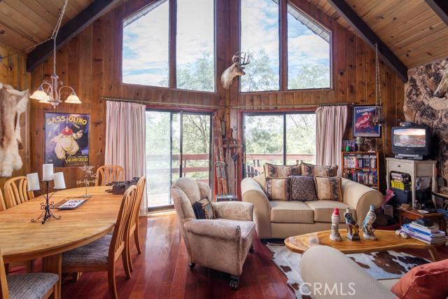 The cabin you have been waiting for! Great value in Lake Arrowhead Woods with FULL LAKE RIGHTS! Only 1.4 miles from Tavern Bay Beach Club, this 2 bedroom/2 bath plus a loft w/full bath has room for the entire family. Tall open beamed living room ceilings with quality tongue and groove. Floor to ceiling wall of glass overlooking a Oak Tree forest. Rear decking over a large backyard, perfect for a dog run or children's play yard. Easy access to front door with no stairs! There's also a lower level game room with pool table. House gets great natural light most the day, arrange your showing today!