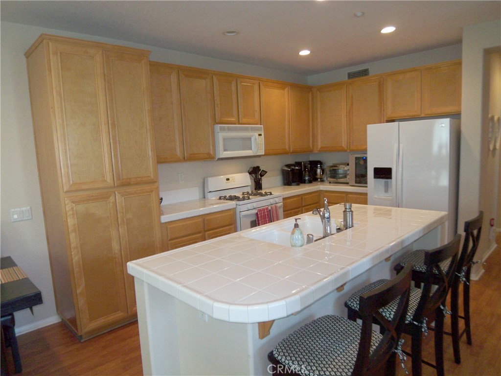 Beautiful Wood Laminate Flooring in Kitchen, Living, Dining, Hallways and Bedrooms + Fresh Neutral Paint Throughout! Private, End Location *Carriage Unit *Light & Bright Davenport Home *Spacious Floorplan *Large Kitchen with Island & Breakfast Bar *Master Suite with Large Walk-In Closet *Spacious Secondary Bedroom *Washer/Dryer Hook-Ups *Tile Countertops in Baths *2 Car Garage Below *Great Neighborhood Amenities. Come see it today!