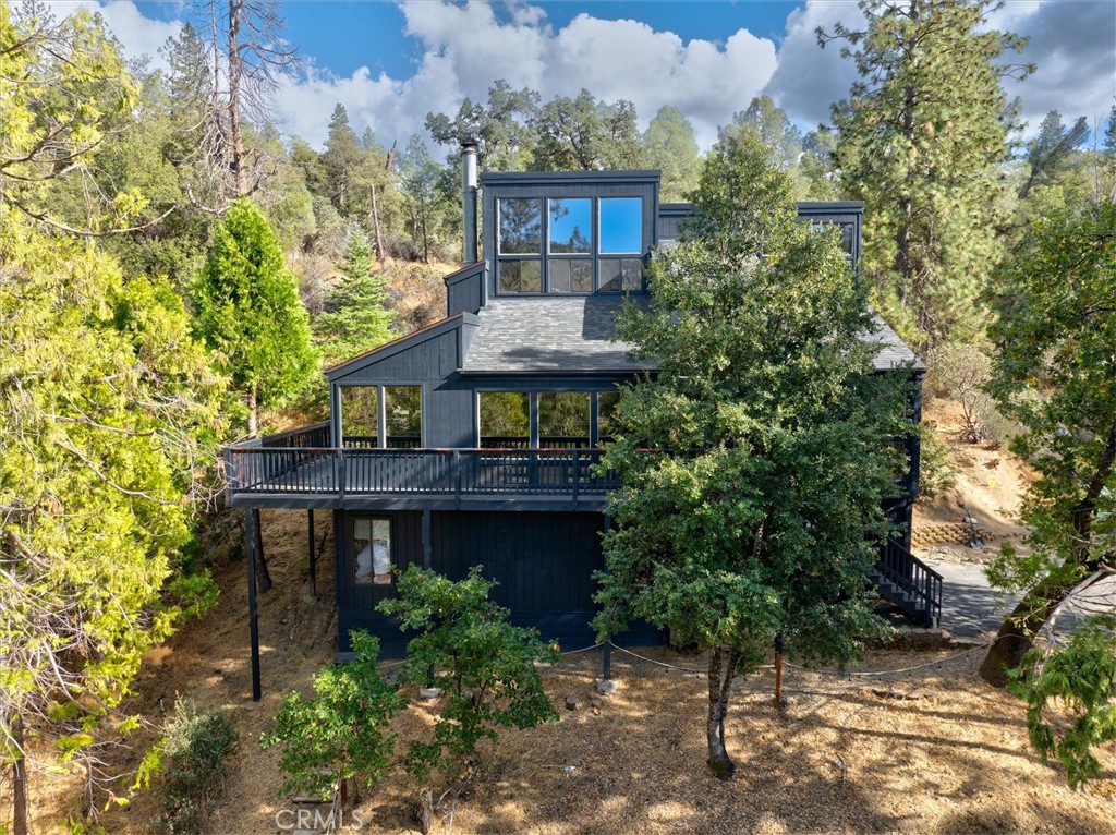 VALUE IMPROVEMENT> Consider this custom built home and creek side vacant land an opportunity to enjoy superb architectural, great location, and if you choose, vacation rental income. Yes, also included in the sale is vacant land parcel number 057490012. Private creek access from this home is across the street. Enjoy the year round serenity of Lewis creek. You and your guest will enjoy the shady shore and inviting cool waters. A short 13 mile drive north on Hwy 41 will grant you access to Yosemite National Park and the Mariposa Grove of Giant Sequoias. Vaulted open beam ceilings throughout the house (yes, in the three bedrooms too) are only one of the features that make this home standout as a cut above the rest. Come experience it yourself. Game room in the garage, wrap around deck, spa, new central heating and air conditioning, on demand propane water heater, sold furnished. Windows, windows, windows; let the light flow through the house and create smiles on all your guests. It's truly an amazing experience to arise for the new day in mountain luxury with plans to take the short ride to Yosemite or Bass Lake with friends and family.
