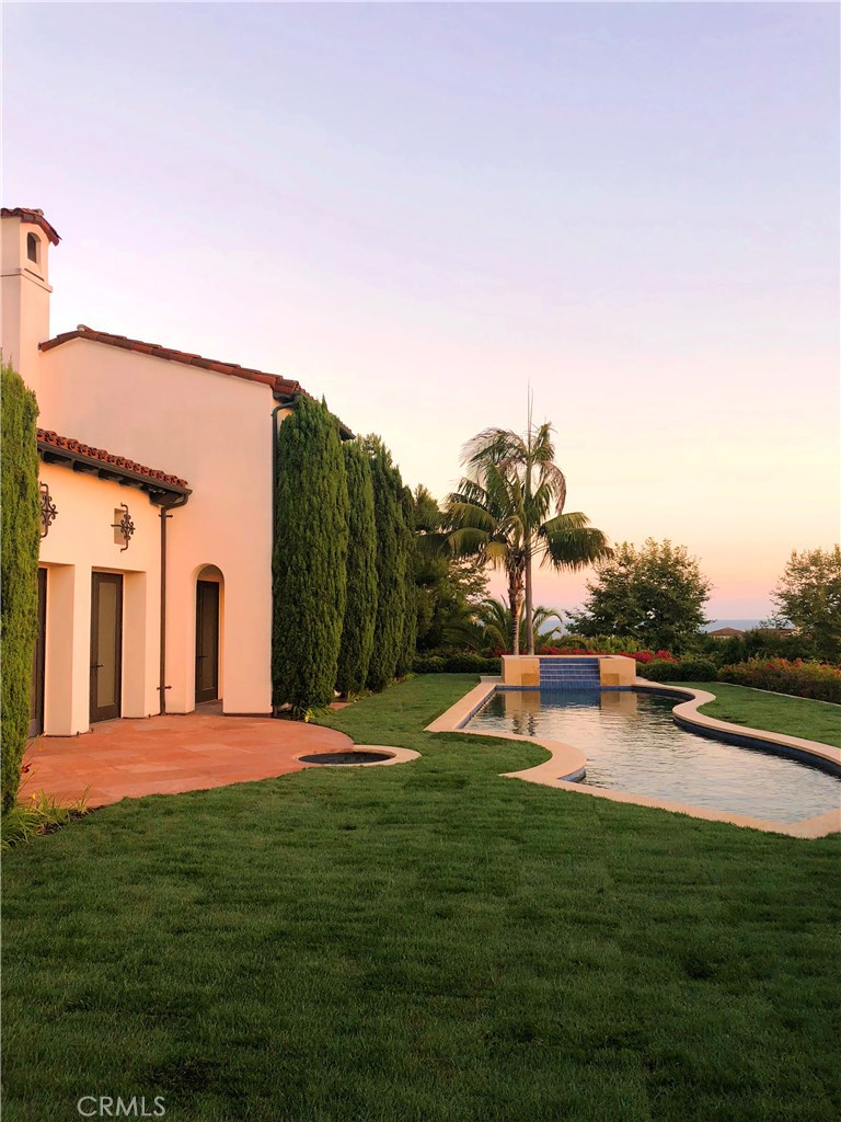 This single story estate occupies one of Crystal Cove’s finest ocean-view parcels of nearly 16,000 sq. ft. with over 120' of view frontage. The elevated, corner location - one of the most sought after in the entire community - affords it sweeping coastline views and exceptional privacy. Meticulously improved and enlarged in a multi-million dollar reconstruction, this exquisite Spanish Colonial residence is configured to capture panoramas of the coastline, ocean, islands and sunsets from throughout. Large informal rooms with 10-14' ceilings are arranged in an eminently livable plan. Walls of French doors open to the surrounding gardens and courtyards. An expanded 5 room master suite includes an ocean view bedroom w/ sitting area, a study, exercise room, an impressive new bath with oversized dressing room. The completely remodeled view kitchen includes dual islands with SubZero, Gaggenau, and Wolfe appliances, and adjoins a caterer’s area. The home also features the consummate residential theater, with tiered seating for 10. Magnificently cultivated gardens include a stylized rose + hedge garden; a forecourt w/ park views; a sunlit courtyard; and an immense ocean garden w/ terraces, lawns, and a large pool + spa. 2 additional bedroom suites, a music room, games room, lounge, and 3-car garage complete the residence. The property is also a short walk from the shopping and beach. This is the very best of Crystal Cove.
