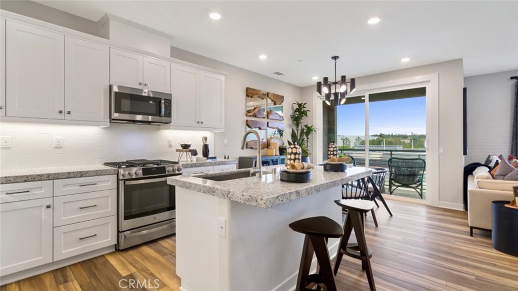Welcome to this Brand New, never lived in model home in the newly built Serrano Summit community. This model home features stainless steel appliances in the kitchen, granite countertops, backsplash, spacious walk in pantry, pull out trays, soft close cabinets. Home has recessed lighting throughout, walk in closet in the master bedroom, double sinks, Moen fixtures and faucets with chrome finish, walk in shower with full tile surround, and many more. This home is right across from a beautiful park, BBQ areas, close to the community club house, tennis courts, pool and many more. Come see it today!