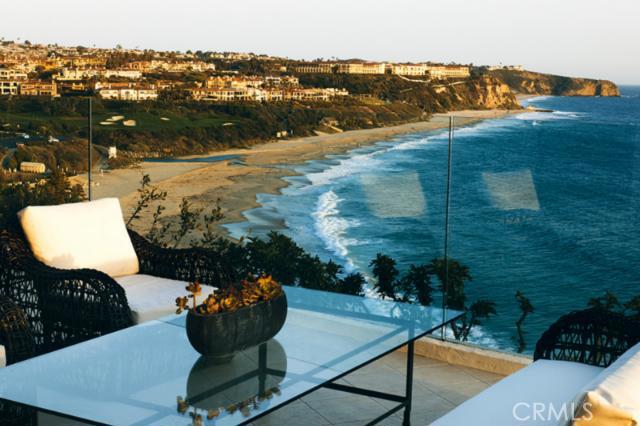 Set atop the oceanfront bluff in the private community of Monarch Bay, this tasteful and sophisticated contemporary-style residence enjoys sweeping panoramas of the ocean and coastline from throughout. Completed in 1997 and freshly restyled and refurbished, the appealing single story design features tastefully appointed interiors and expansive rooms in over 5,000 square feet of living area. Ideal for living and entertaining, there is a comfortable flow between the public rooms and the oversized oceanfront terrace. Walls of floor-to-ceiling glass take in the vast sea views along its waterside exposure. Situated around a delightful and private courtyard with swimming pool, the residence incorporates all of the defining elements of timeless California design. Oversized rooms, high ceilings and skylights throughout create a relaxing interior bathed in light and ocean views. The generous scale is continued in the ocean view master suite which features twin baths and dressing areas. Three additional bedrooms are situated surround the courtyard. The entire house is discreetly set away from the street by a gated courtyard entrance and private motor court. Monarch Bay’s private oceanfront beach club – the only one of its kind in Orange County – is a moment away.