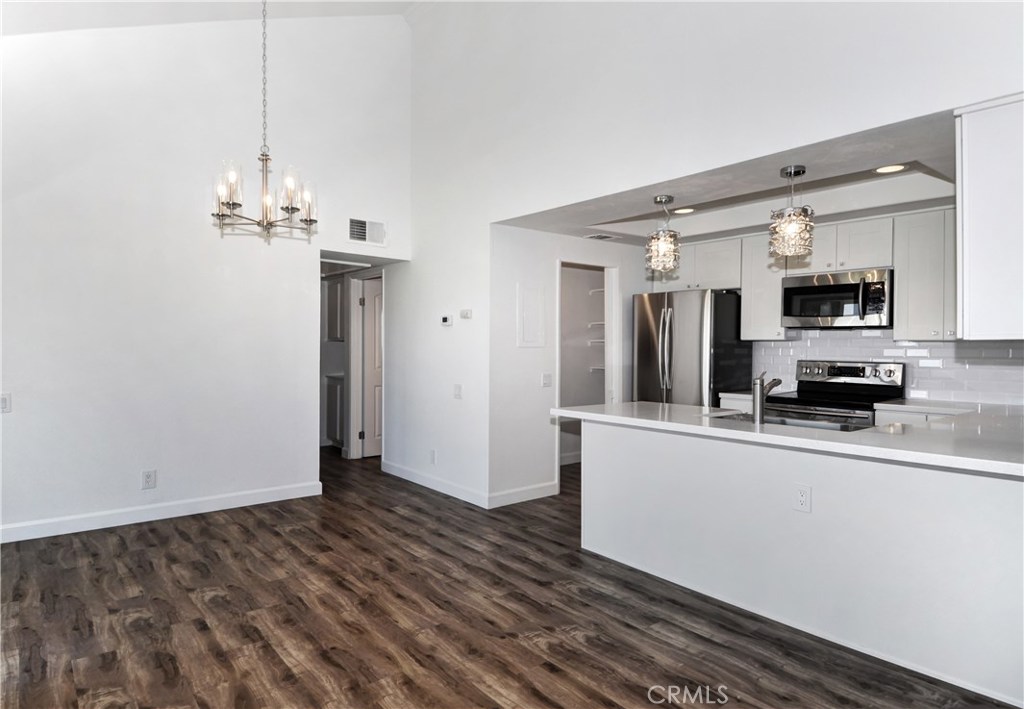Top Floor Penthouse unit COMPLETELY RENOVATED with gorgeous VIEW. Beautiful hardwood floor throughout the house. Brand new contemporary style kitchen. Upgraded bathrooms. Fresh paint throughout the house. New doors. Upgraded appliances and brand new fridge and washer dryer. Views of Turtle Rock Hills and Spectrum Lights from Two Balconies. The unit is south facing thus provides tremendous amount of natural lighting and privacy as an end unit. Elevator access from garage or front lobby. Resort amenities include pool/spa;lighted tennis courts,playground and clubhouse.